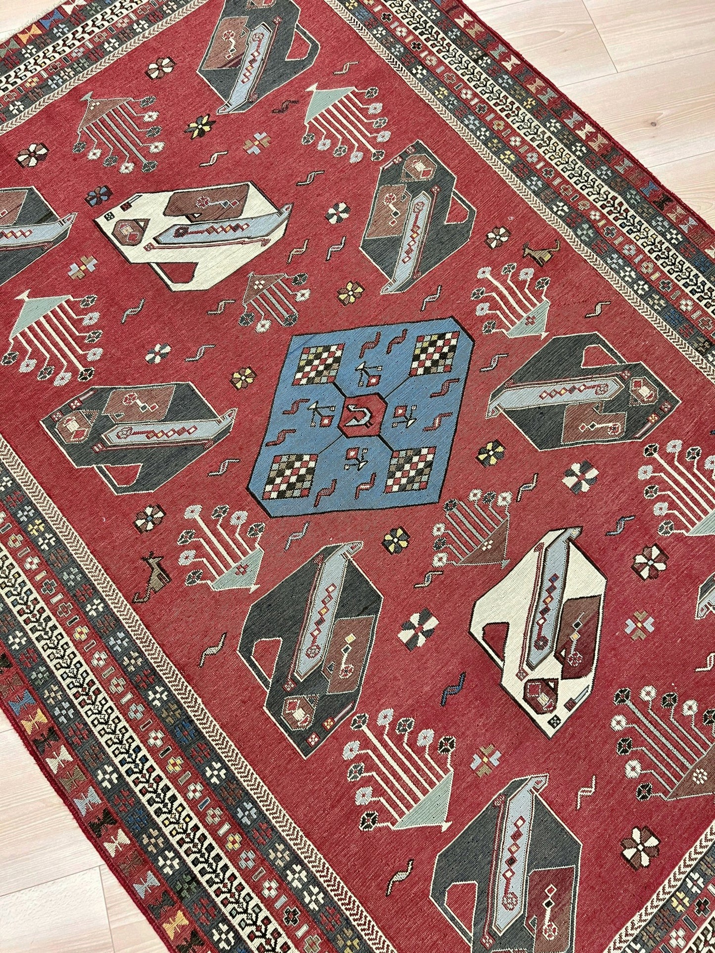 Vintage Armenian soumak rug with pictorial motifs in madder red, slate blue, ivory, and charcoal, 4x6 size.