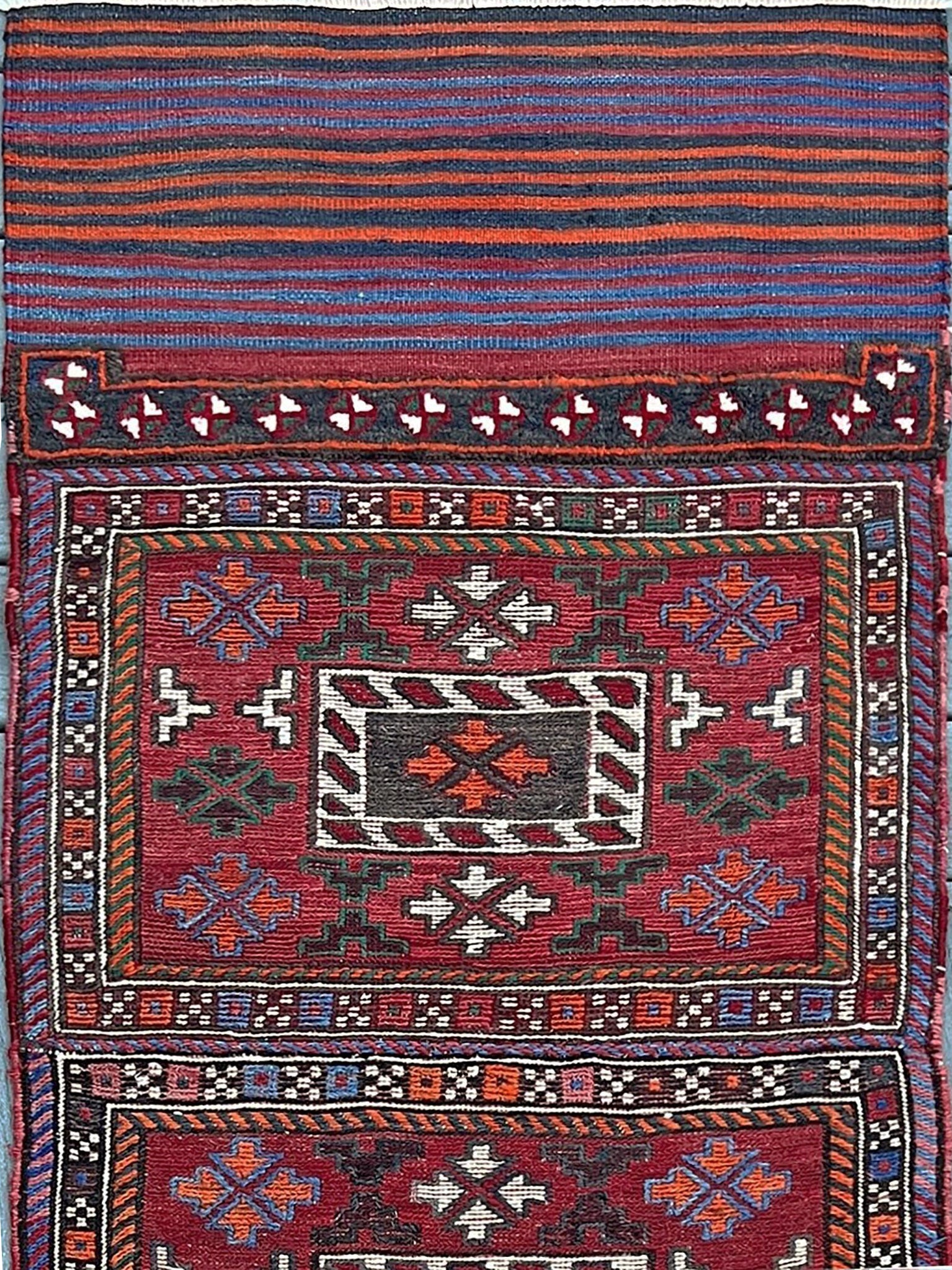 Vintage Bakhtiari Khorjin saddle bag rug 2x6 — 1940s Persian tribal runner handwoven with flatweave, pile, and soumak techniques in crimson, indigo, orange, and ivory — antique wool rug from Northwest Persia, Indigo Rugs Burlingame CA.