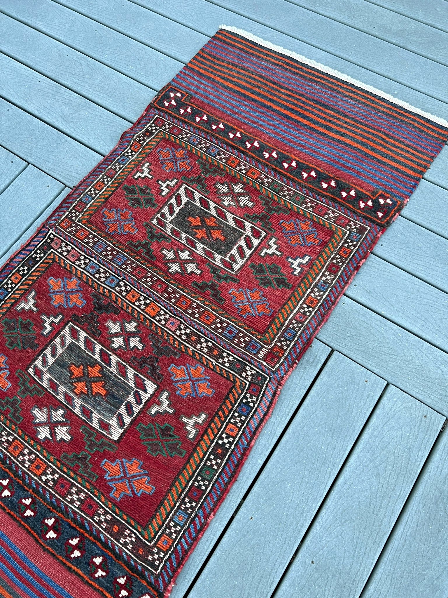 Vintage Bakhtiari Khorjin saddle bag rug 2x6 — 1940s Persian tribal runner handwoven with flatweave, pile, and soumak techniques in crimson, indigo, orange, and ivory — antique wool rug from Northwest Persia, Indigo Rugs Burlingame CA.