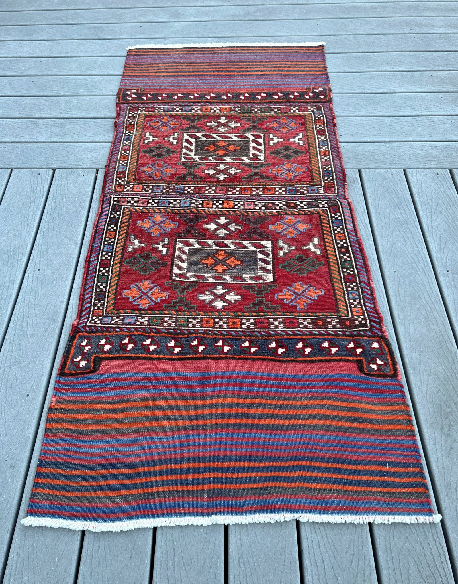 Vintage Bakhtiari Khorjin saddle bag rug 2x6 — 1940s Persian tribal runner handwoven with flatweave, pile, and soumak techniques in crimson, indigo, orange, and ivory — antique wool rug from Northwest Persia, Indigo Rugs Burlingame CA.