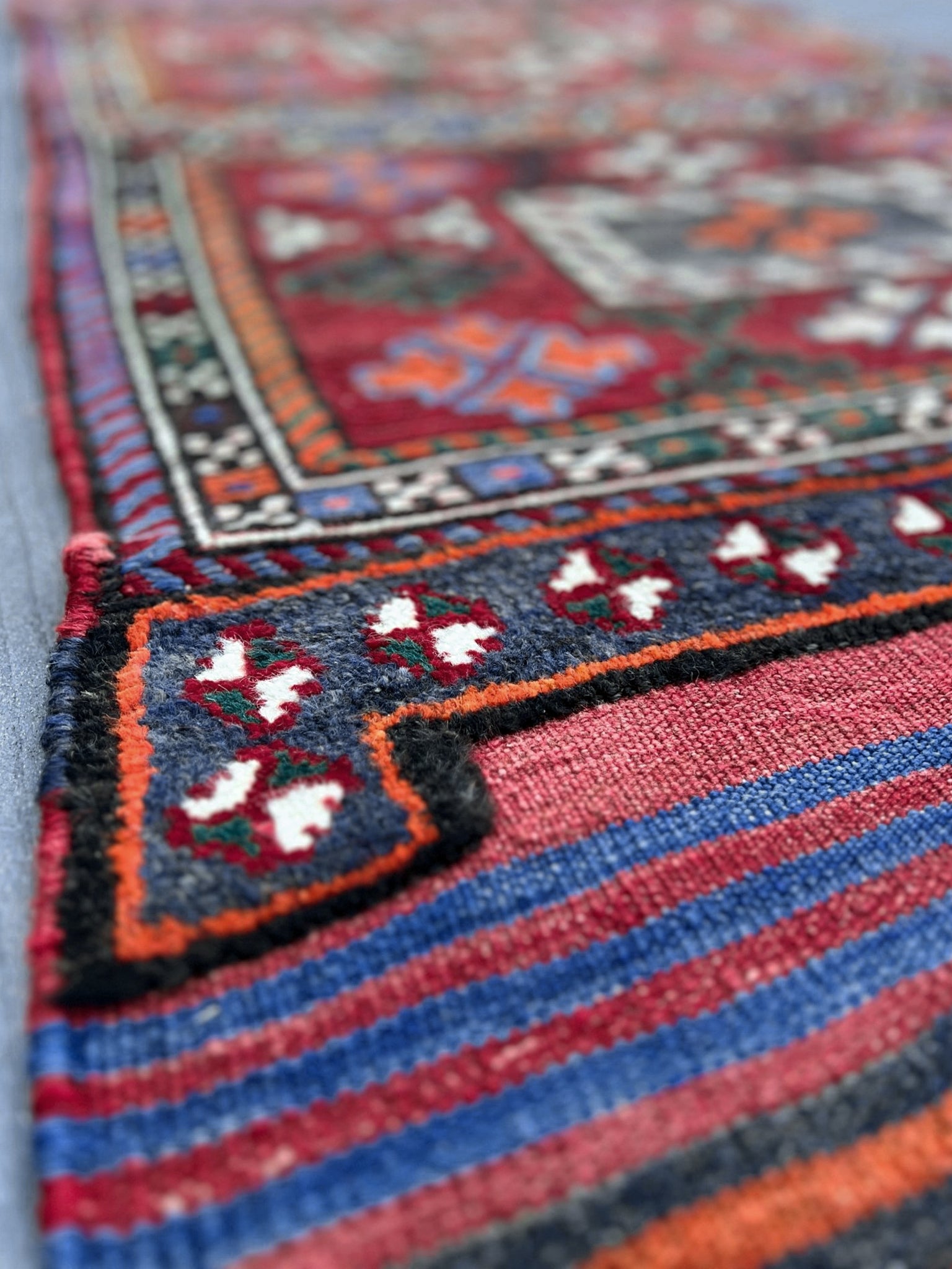 Vintage Bakhtiari Khorjin saddle bag rug 2x6 — 1940s Persian tribal runner handwoven with flatweave, pile, and soumak techniques in crimson, indigo, orange, and ivory — antique wool rug from Northwest Persia, Indigo Rugs Burlingame CA.