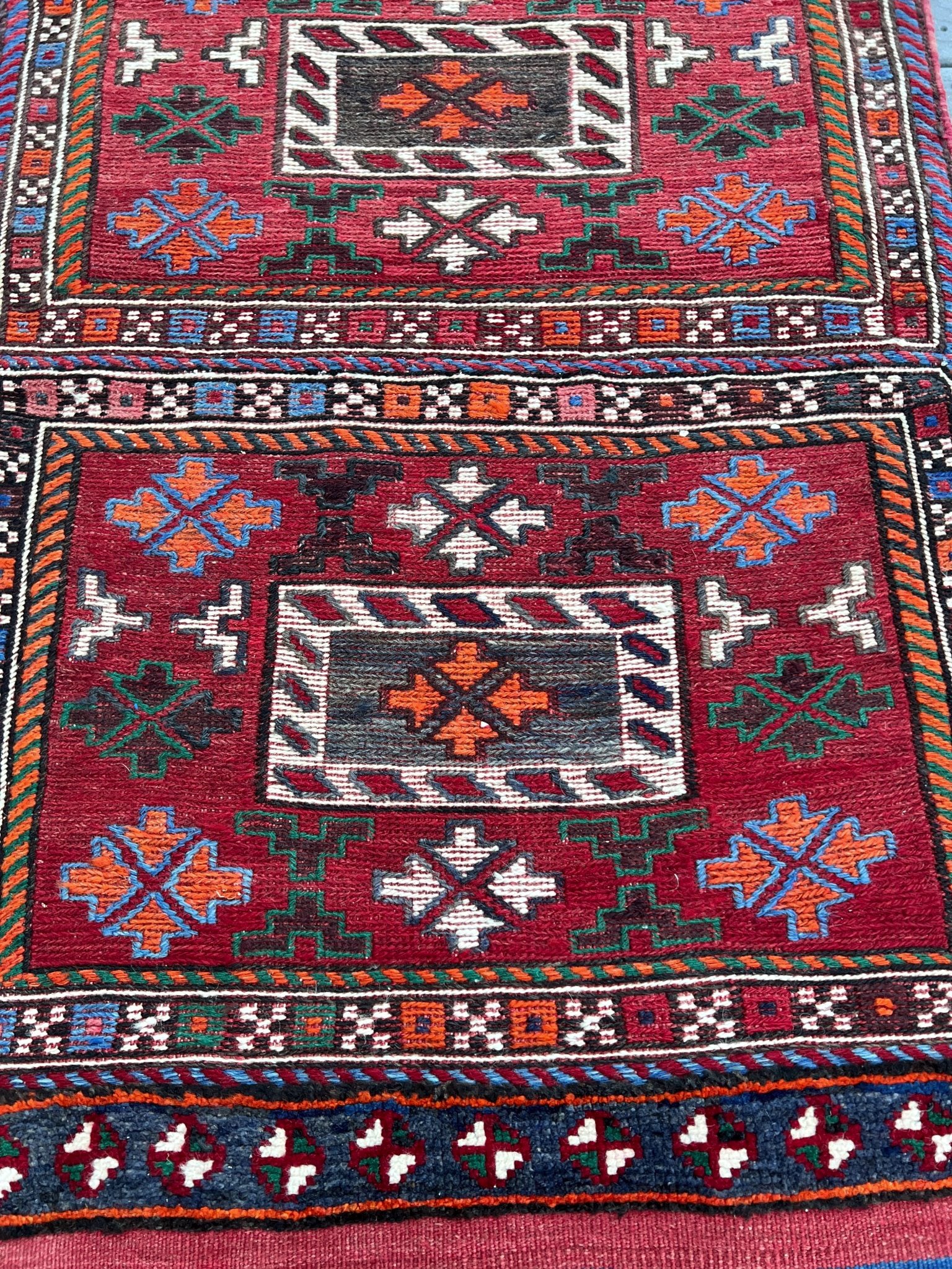 Vintage Bakhtiari Khorjin saddle bag rug 2x6 — 1940s Persian tribal runner handwoven with flatweave, pile, and soumak techniques in crimson, indigo, orange, and ivory — antique wool rug from Northwest Persia, Indigo Rugs Burlingame CA.