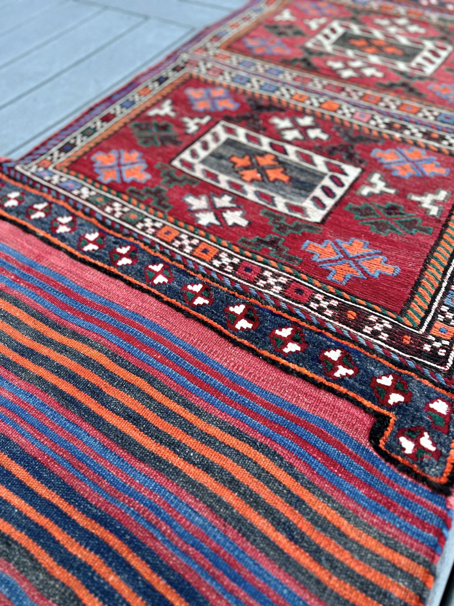 Vintage Bakhtiari Khorjin saddle bag rug 2x6 — 1940s Persian tribal runner handwoven with flatweave, pile, and soumak techniques in crimson, indigo, orange, and ivory — antique wool rug from Northwest Persia, Indigo Rugs Burlingame CA.