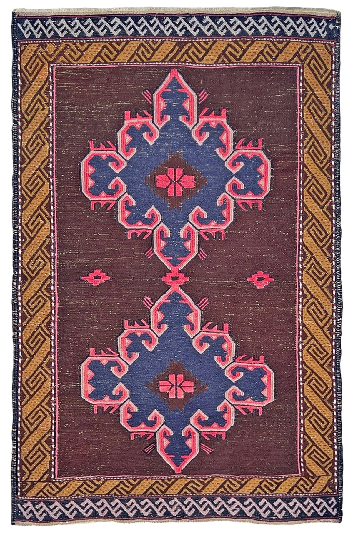 A traditional flatweave area rug with a dark reddish-brown field, featuring two large blue and pink geometric medallions, a gold and brown patterned border, and a white and dark blue geometric edge.