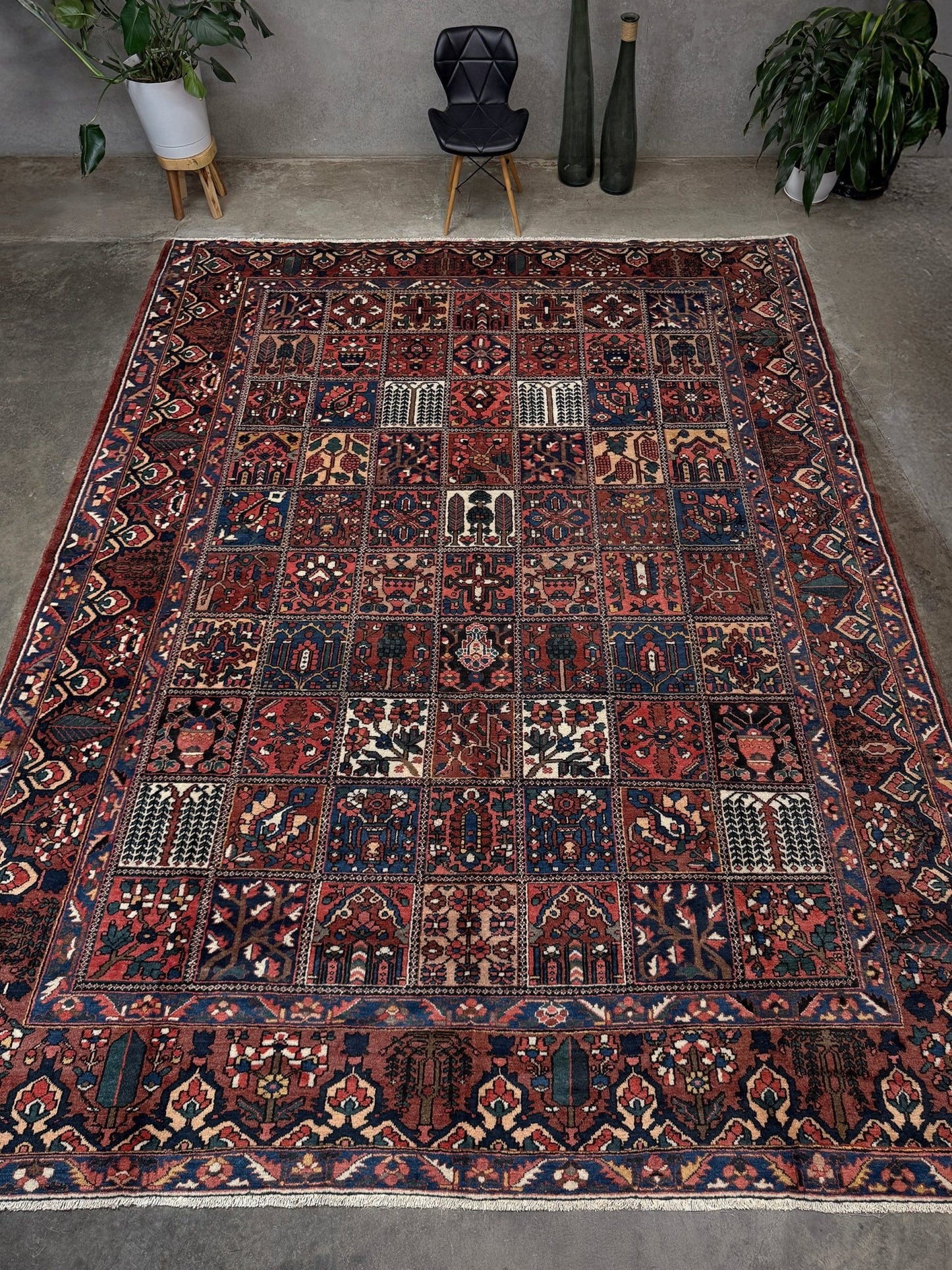 10x13 handmade Persian Bakhtiari vintage rug with garden panel design, floral motifs, and red and navy tones — shown in living room at Indigo Rugs, Burlingame — San Francisco Bay Area with free shipping