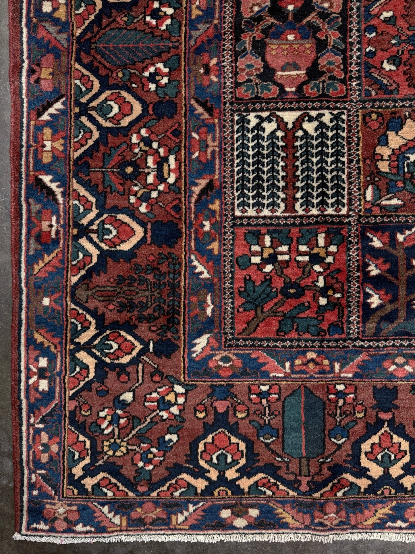 10x13 handmade Persian Bakhtiari vintage rug with garden panel design, floral motifs, and red and navy tones — shown in living room at Indigo Rugs, Burlingame — San Francisco Bay Area with free shipping