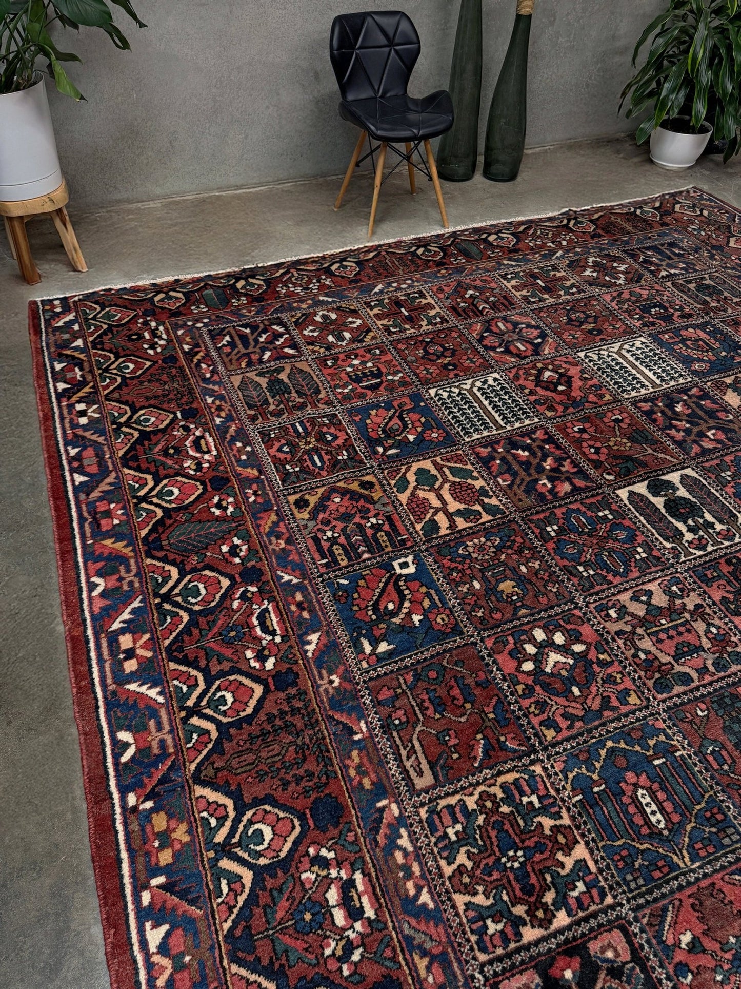 10x13 handmade Persian Bakhtiari vintage rug with garden panel design, floral motifs, and red and navy tones — shown in living room at Indigo Rugs, Burlingame — San Francisco Bay Area with free shipping