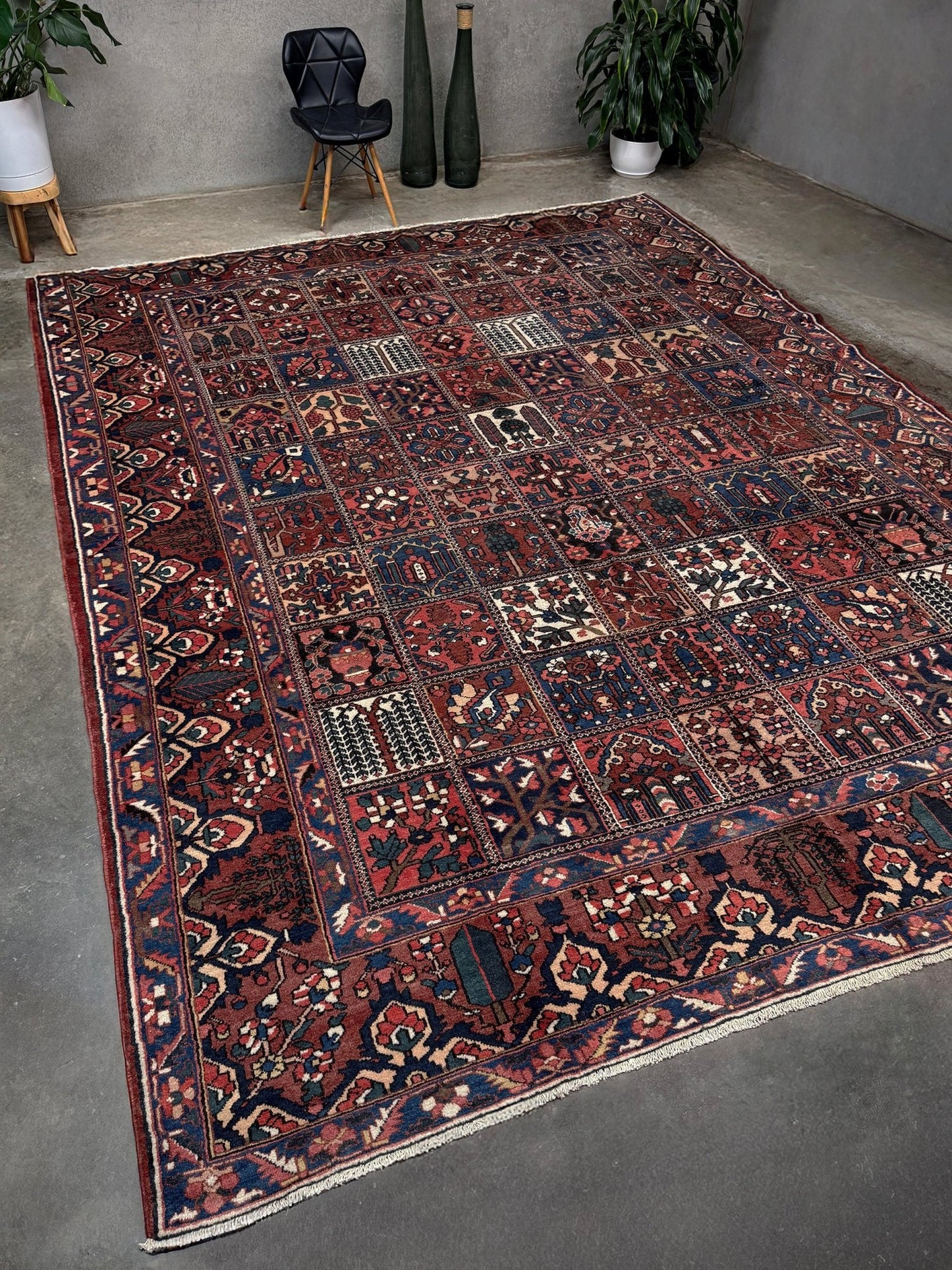 10x13 handmade Persian Bakhtiari vintage rug with garden panel design, floral motifs, and red and navy tones — shown in living room at Indigo Rugs, Burlingame — San Francisco Bay Area with free shipping