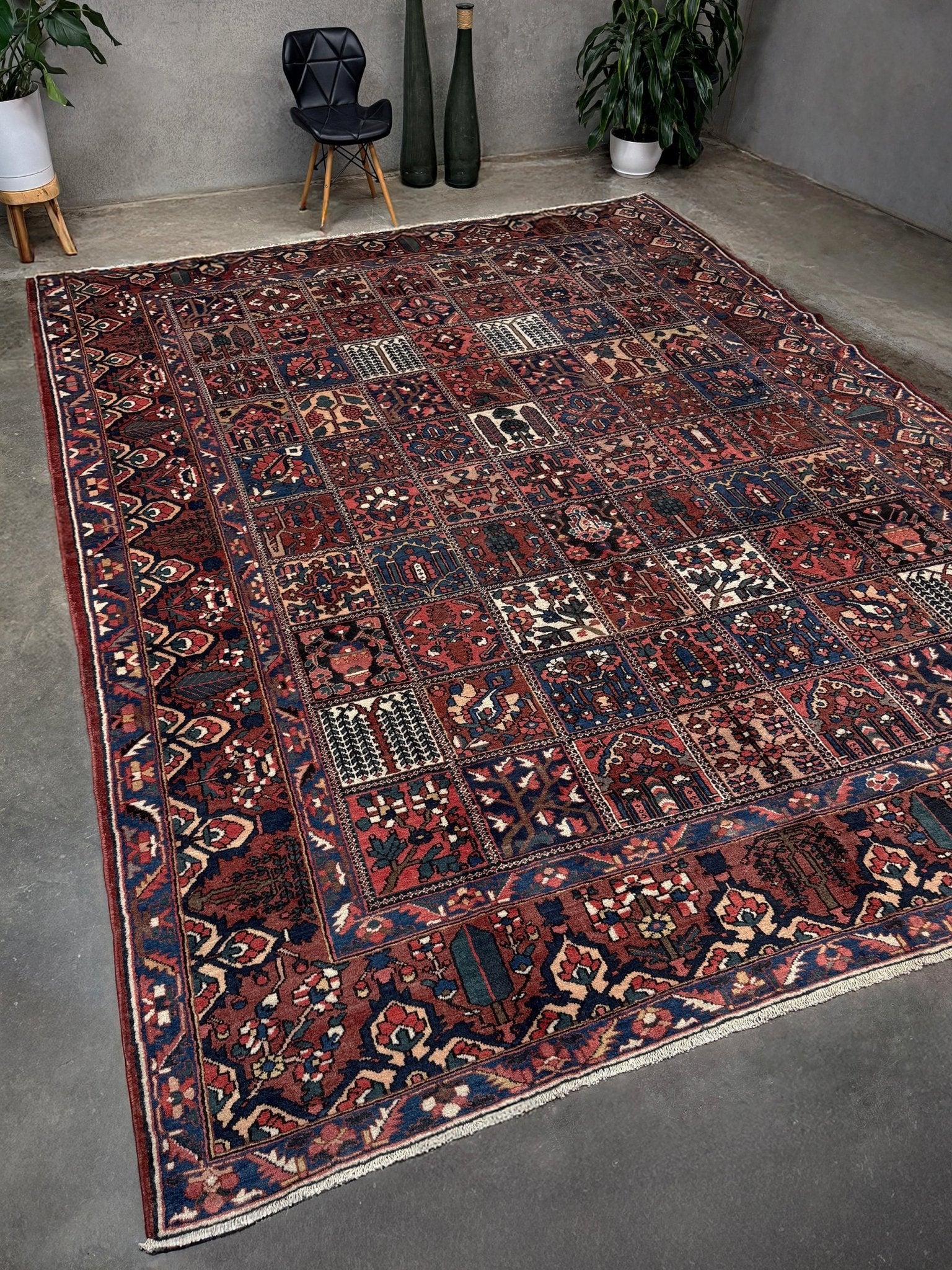 10x13 handmade Persian Bakhtiari vintage rug with garden panel design, floral motifs, and red and navy tones — shown in living room at Indigo Rugs, Burlingame — San Francisco Bay Area with free shipping