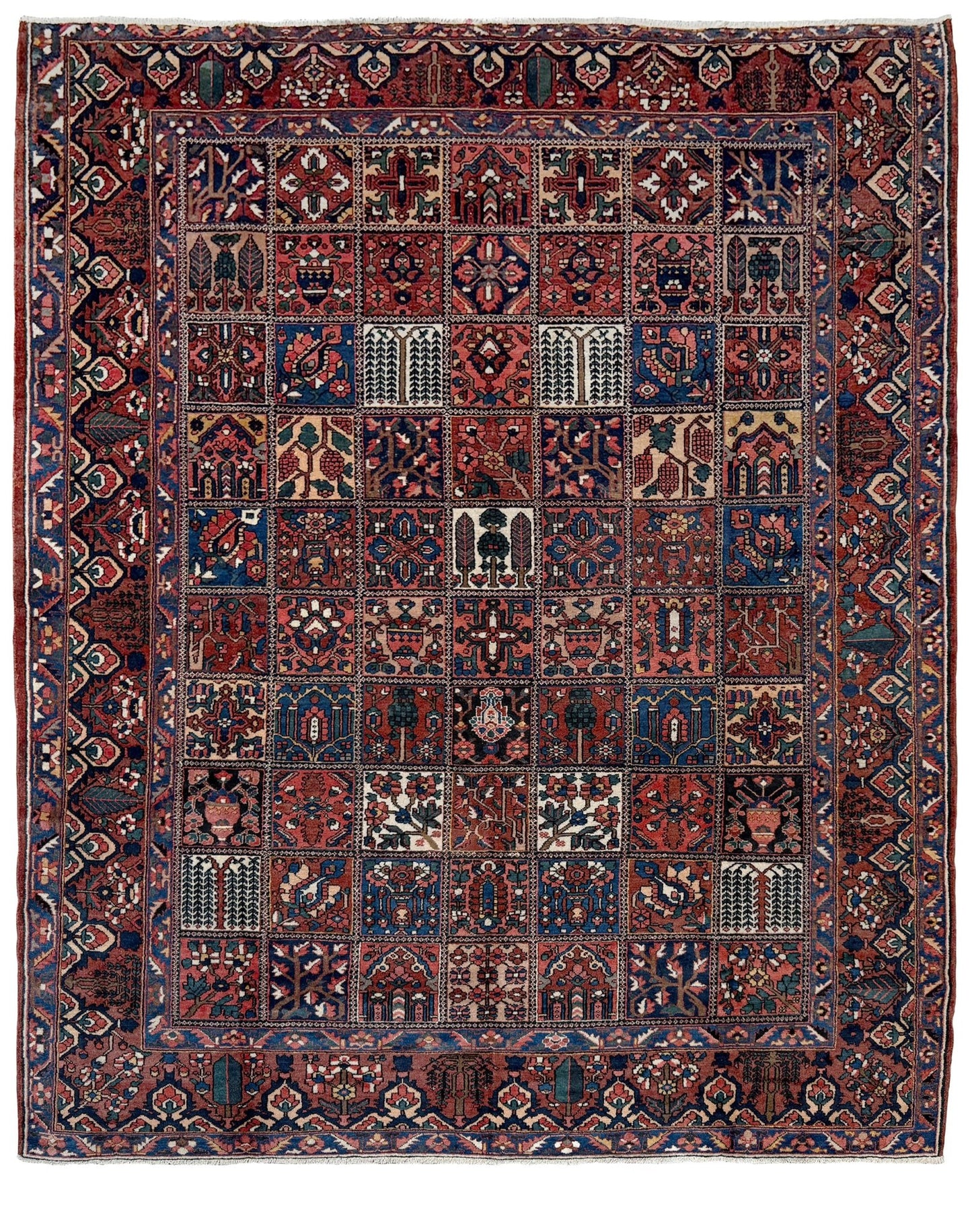 10x13 handmade Persian Bakhtiari vintage rug with garden panel design, floral motifs, and red and navy tones — shown in living room at Indigo Rugs, Burlingame — San Francisco Bay Area with free shipping
