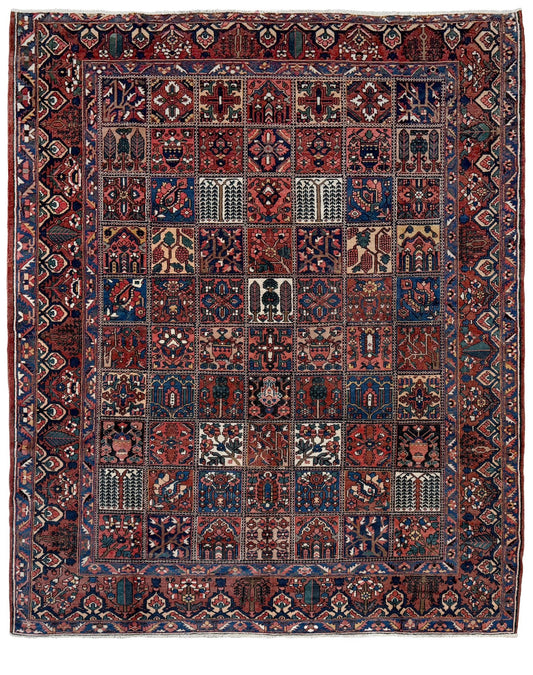 10x13 handmade Persian Bakhtiari vintage rug with garden panel design, floral motifs, and red and navy tones — shown in living room at Indigo Rugs, Burlingame — San Francisco Bay Area with free shipping