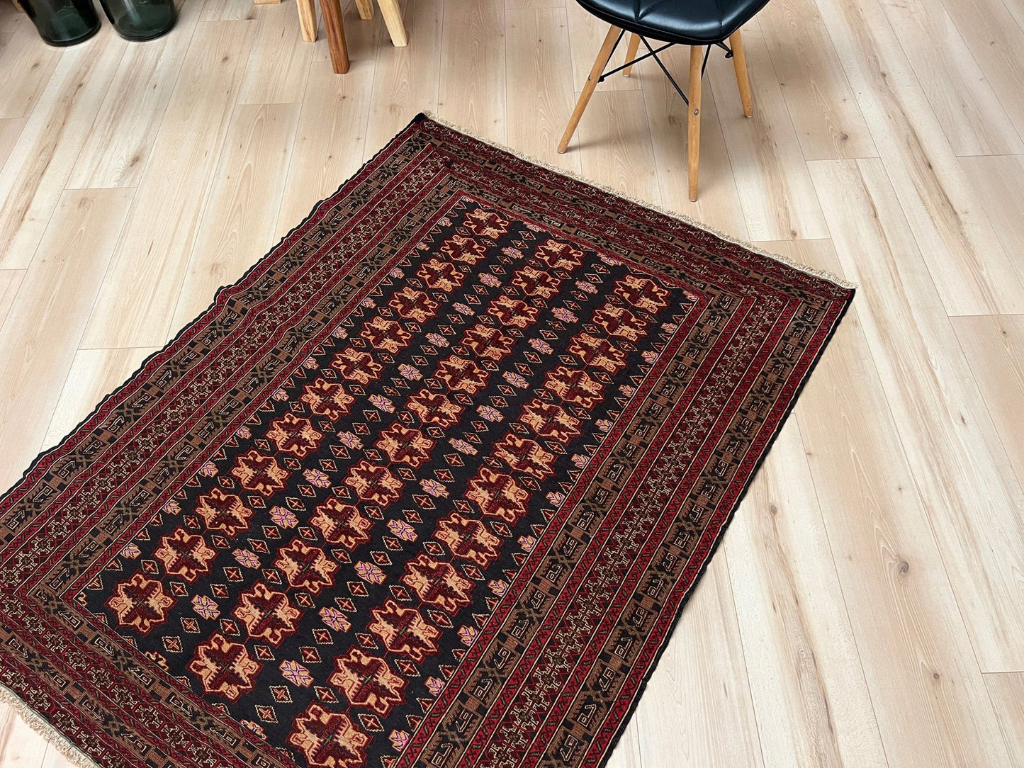 Vintage Caucasian Soumak flatweave rug with charcoal gray field, madder red rose motifs, and intricate tribal borders — handmade wool wall hanging from the 1950s, available at Indigo Rugs, the best rug shop in San Francisco Bay Area, Burlingame CA.
