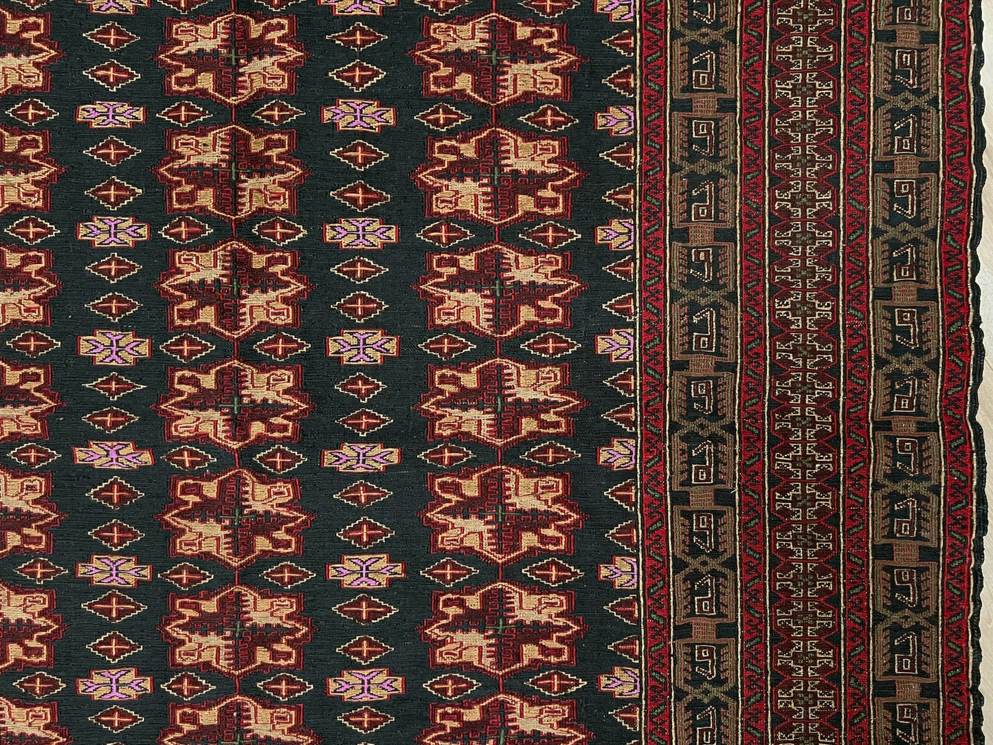 Vintage Caucasian Soumak flatweave rug with charcoal gray field, madder red rose motifs, and intricate tribal borders — handmade wool wall hanging from the 1950s, available at Indigo Rugs, the best rug shop in San Francisco Bay Area, Burlingame CA.