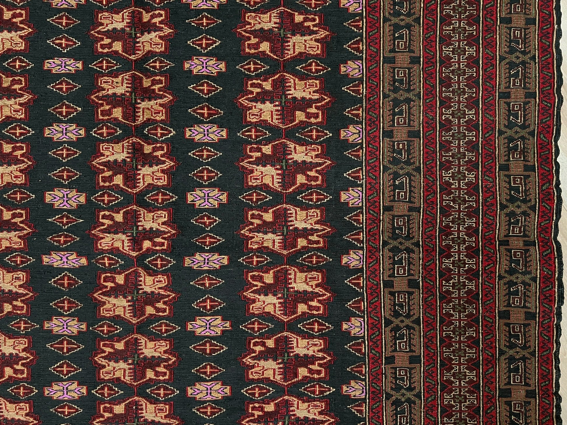 Vintage Caucasian Soumak flatweave rug with charcoal gray field, madder red rose motifs, and intricate tribal borders — handmade wool wall hanging from the 1950s, available at Indigo Rugs, the best rug shop in San Francisco Bay Area, Burlingame CA.