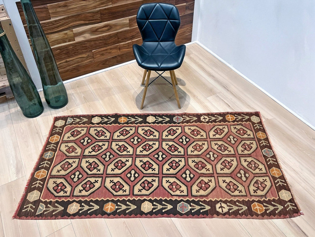 Vintage Floral Balkan kilim rug in brown earthy tones with geometric floral motifs — handmade wool rug, available at Indigo Rugs, the best rug shop in San Francisco Bay Area, Burlingame CA.