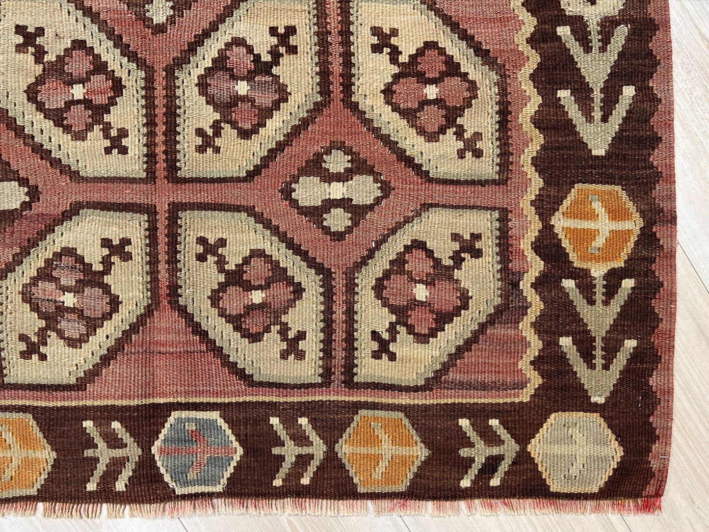 Vintage Floral Balkan kilim flatweave rug in blush terracotta, cream, and cocoa brown with geometric floral motifs — handmade wool wall hanging from the 1960s, available at Indigo Rugs, the best rug shop in San Francisco Bay Area, Burlingame CA.