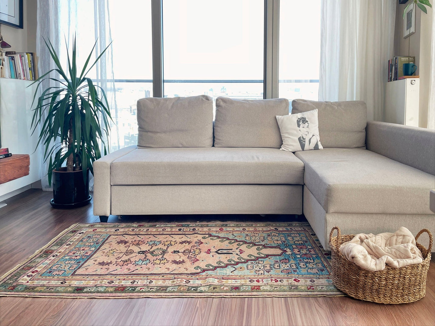 Beige sectional sofa in a living room with a patterned rug and decorative items. 3x5 Kirsehir mucur antique turkish prayer rug wall art shop san francisco bay area. Wall hanging wool antique rug. Oriental rug shop. Buy handmade wool rug