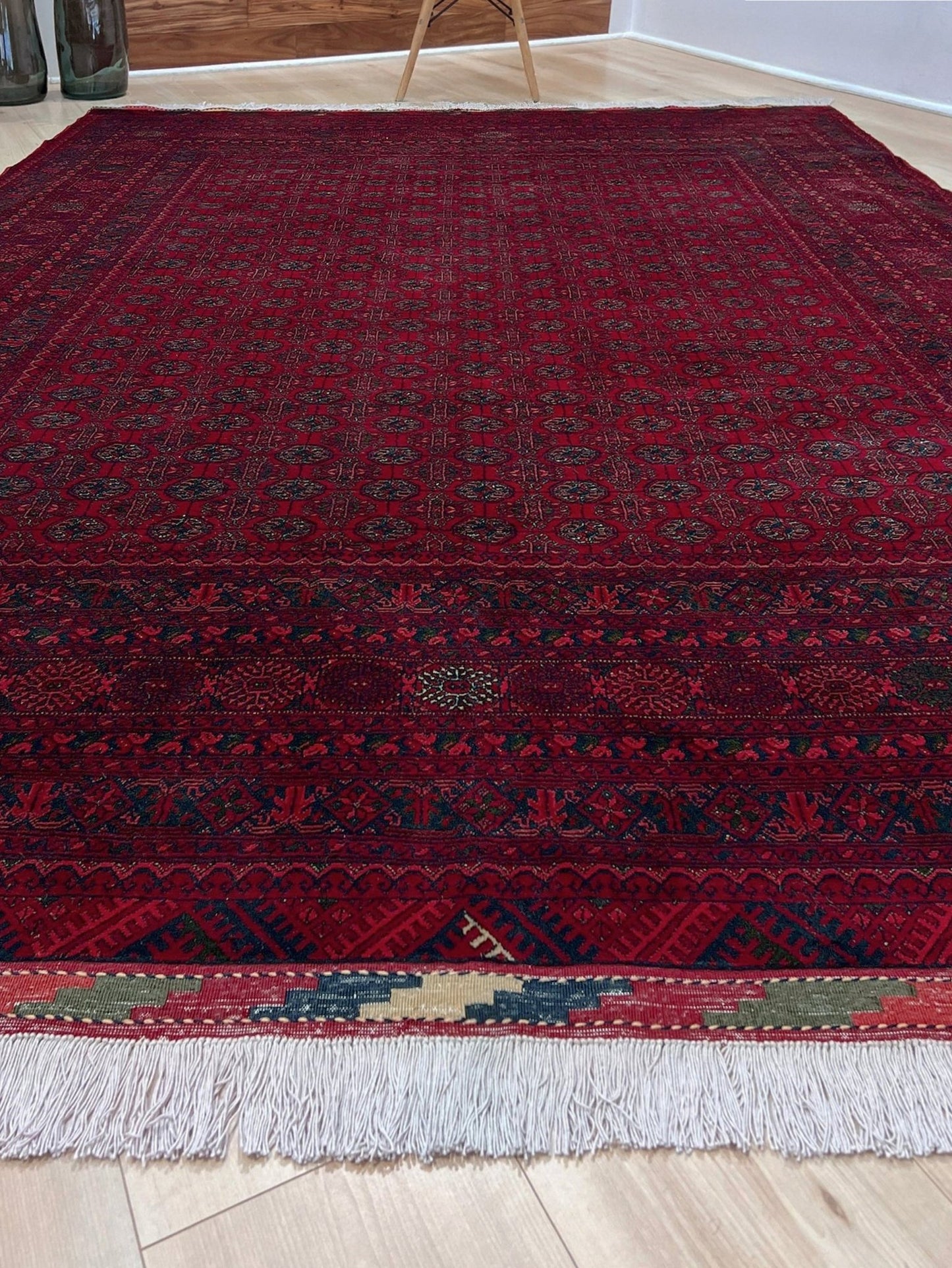 Traditional Turkmen Khoja Roshnai rug with crimson field, repeating gul motifs, handmade merino wool area rug 7x10 with velvety pile from Indigo Rugs Burlingame Bay Area.