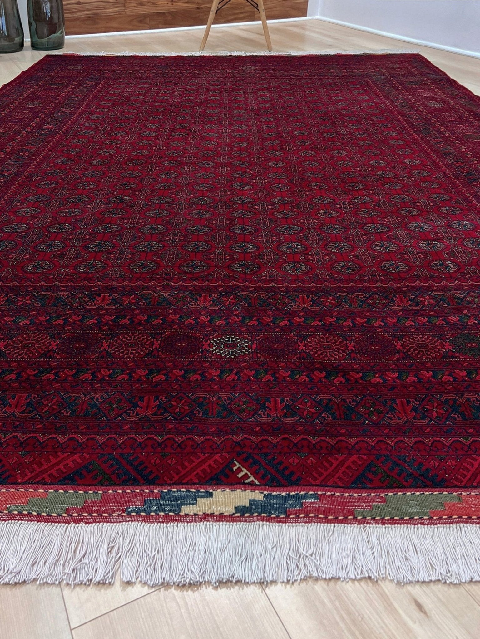 Traditional Turkmen Khoja Roshnai rug with crimson field, repeating gul motifs, handmade merino wool area rug 7x10 with velvety pile from Indigo Rugs Burlingame Bay Area.