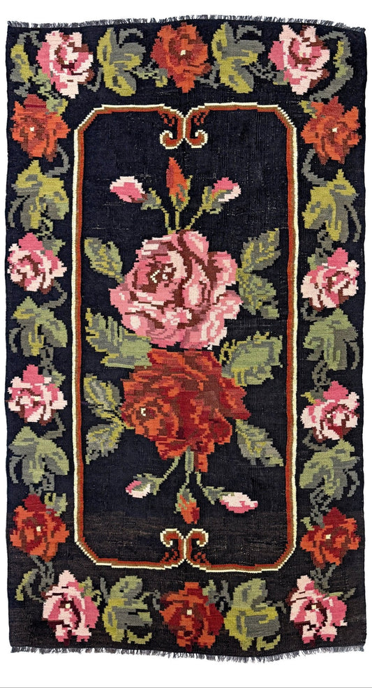 Decorative rug with floral pattern on a dark background. Vintage moldovan floral kilim rug 5x8 handmade rose design black background flatweave 1960s eastern european wool rug san francisco bay area rug shop indigo rugs