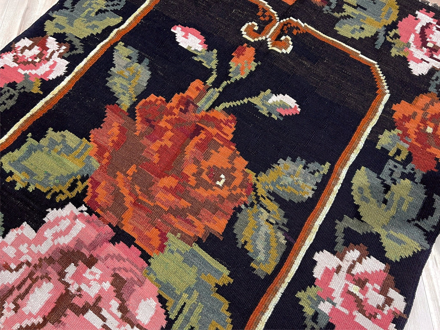 Floral patterned rug with intricate design on a dark background. Vintage moldovan floral kilim rug 5x8 handmade rose design black background flatweave 1960s eastern european wool rug san francisco bay area rug shop indigo rugs