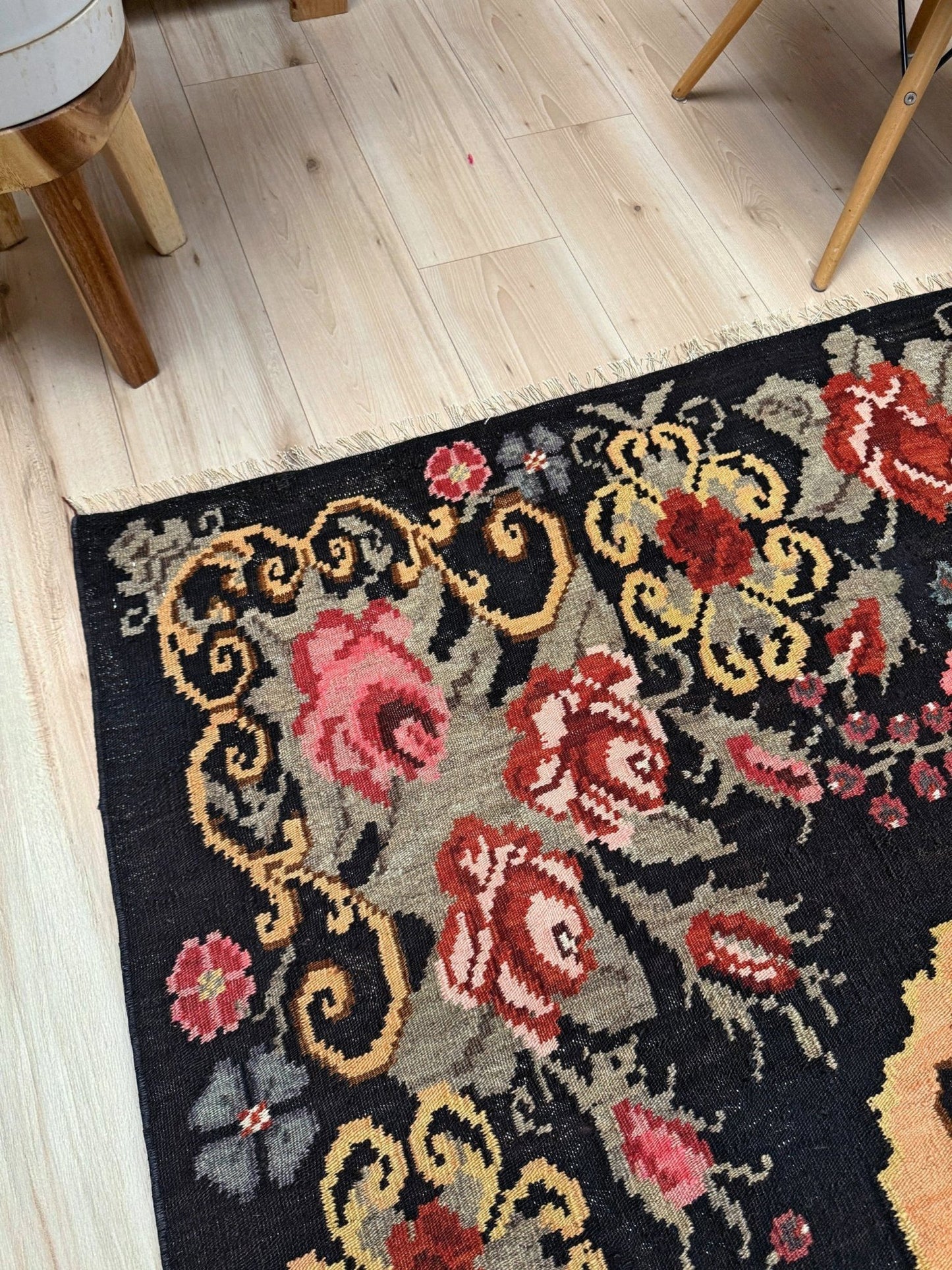Decorative moldovan rose kilim rug with floral patterns on a wooden floor