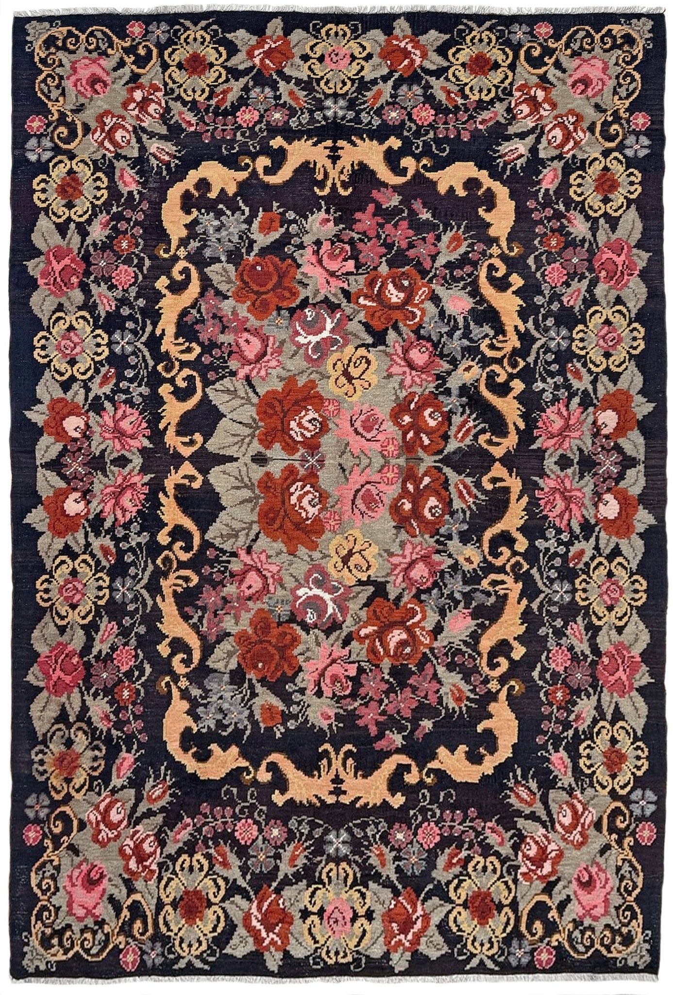 Decorative vintage moldovan rose kilim rug with floral and paisley patterns on a dark background
