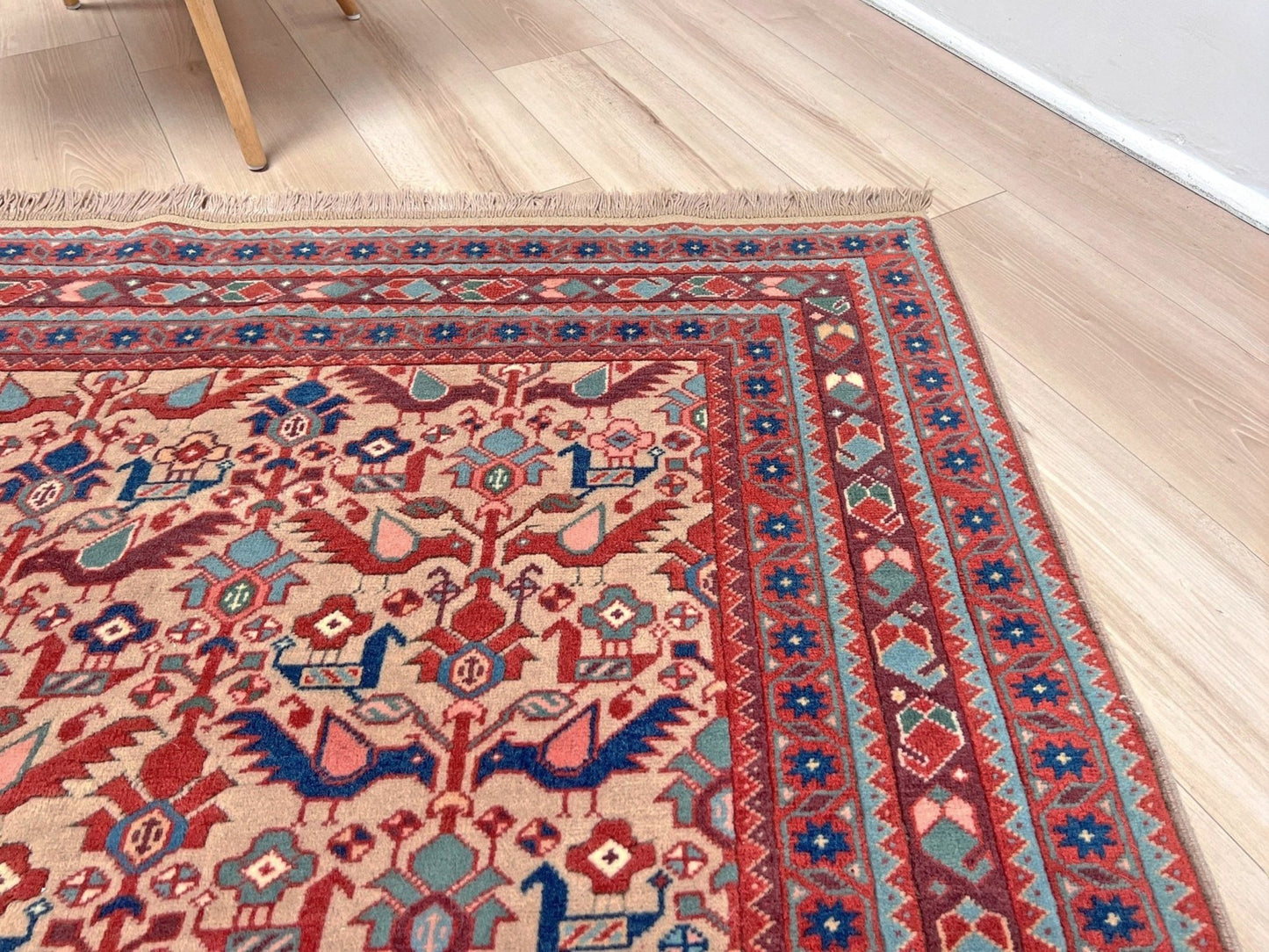 Brand new 6x9 handmade Turkish Tree of Life rug in muted peach with birds, floral motifs, coral red and blue accents, traditional wool area rug from Indigo Rugs Burlingame Bay Area.