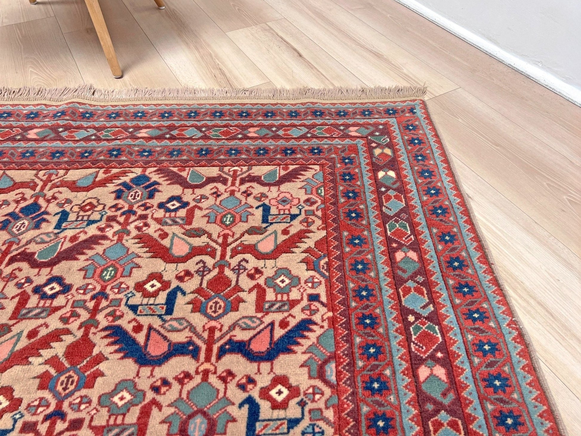 Brand new 6x9 handmade Turkish Tree of Life rug in muted peach with birds, floral motifs, coral red and blue accents, traditional wool area rug from Indigo Rugs Burlingame Bay Area.