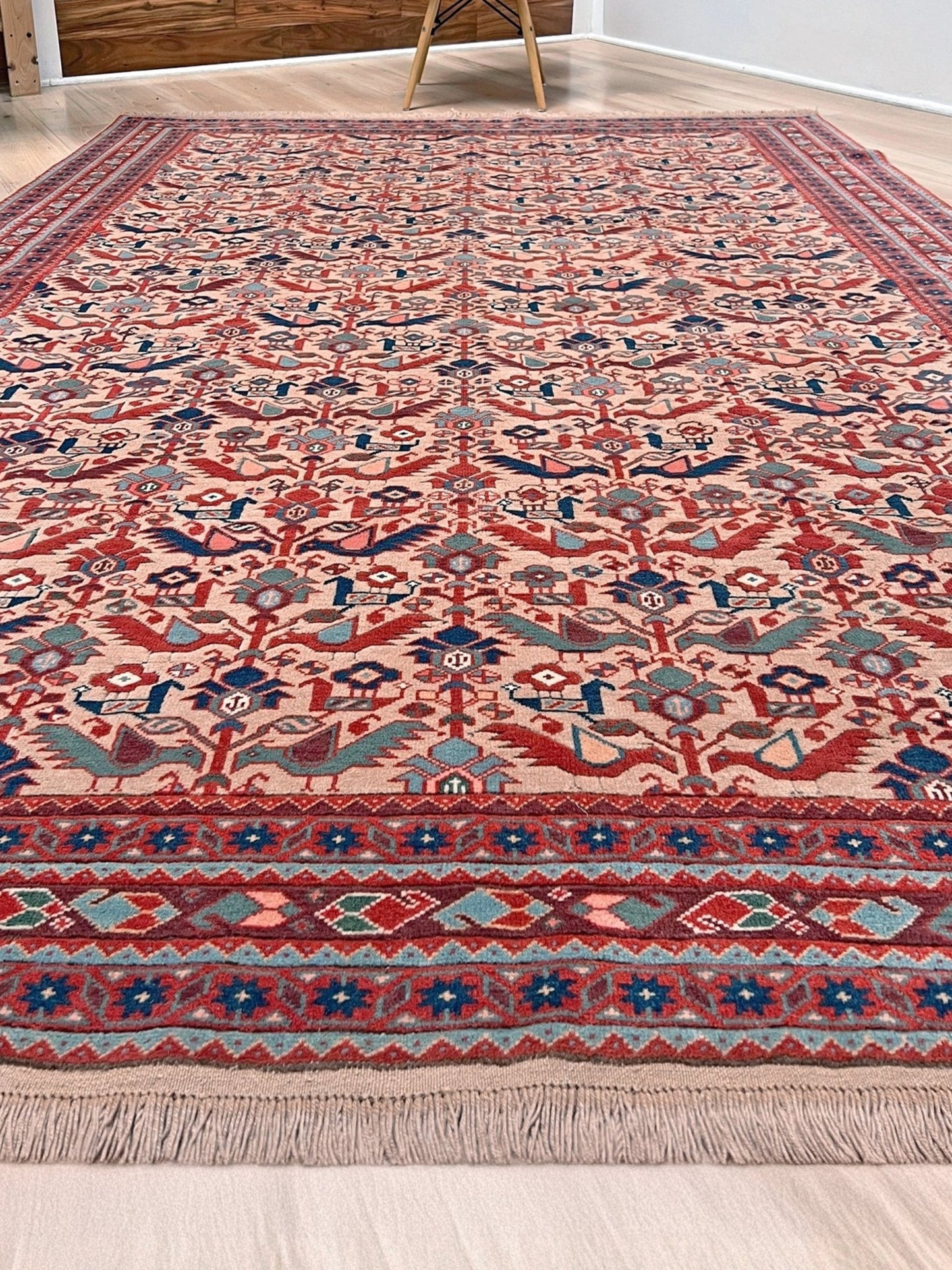 Brand new 6x9 handmade Turkish Tree of Life rug in muted peach with birds, floral motifs, coral red and blue accents, traditional wool area rug from Indigo Rugs Burlingame Bay Area.