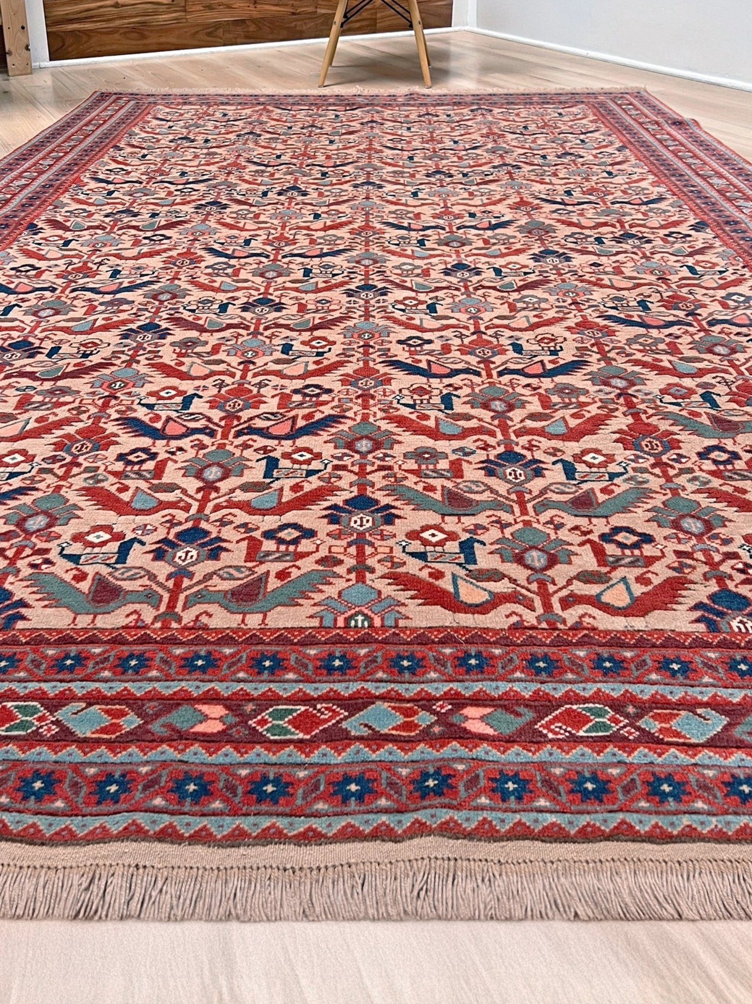 Brand new 6x9 handmade Turkish Tree of Life rug in muted peach with birds, floral motifs, coral red and blue accents, traditional wool area rug from Indigo Rugs Burlingame Bay Area.
