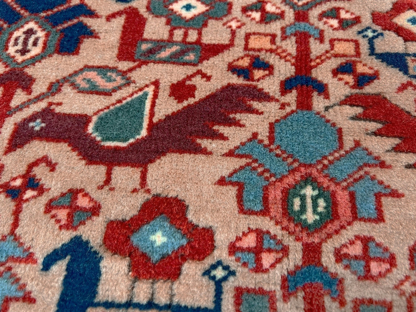 Brand new 6x9 handmade Turkish Tree of Life rug in muted peach with birds, floral motifs, coral red and blue accents, traditional wool area rug from Indigo Rugs Burlingame Bay Area.