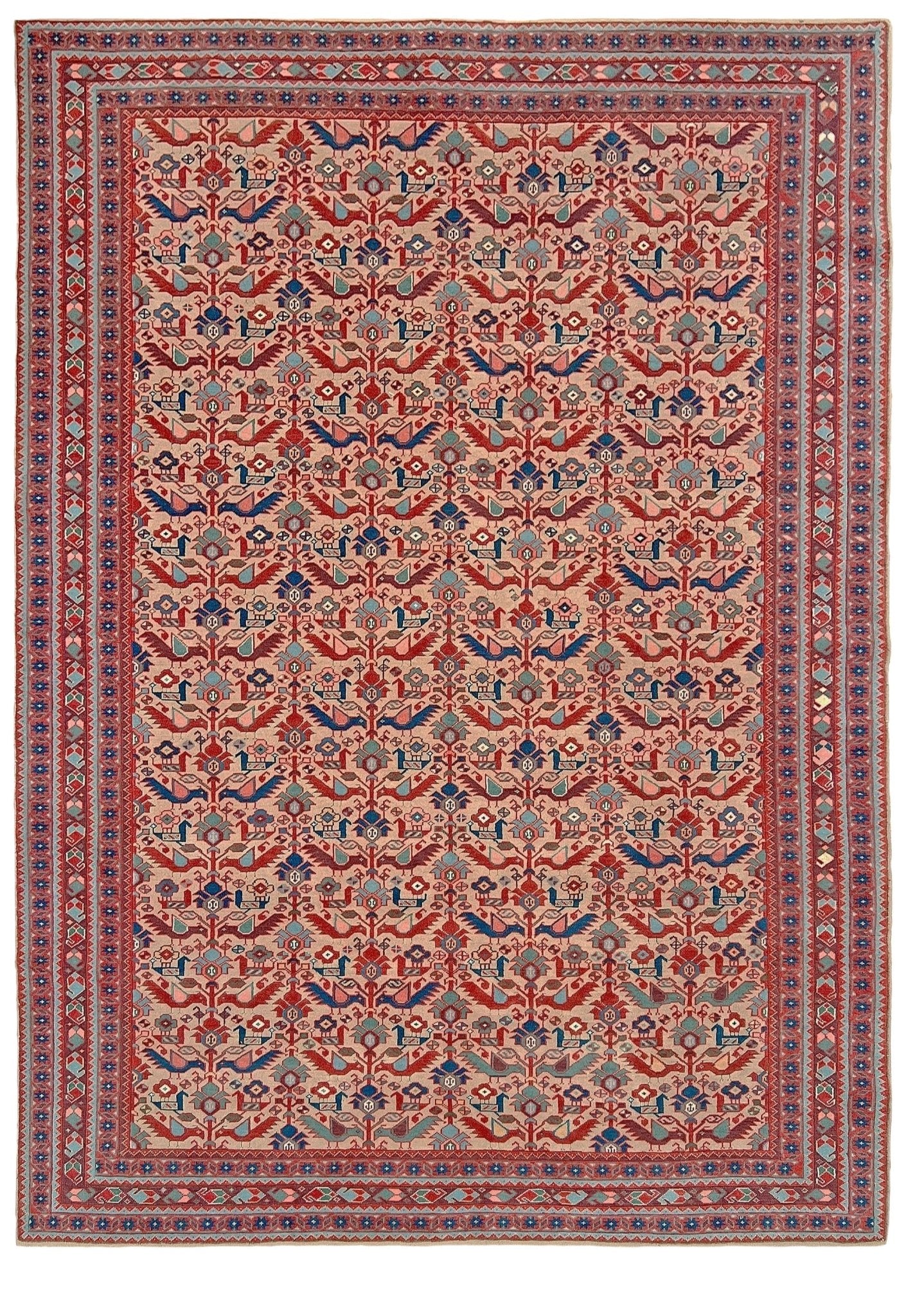 Brand new 6x9 handmade Turkish Tree of Life rug in pale salmon pink with birds, floral motifs, coral red and blue accents, traditional wool area rug from Indigo Rugs Burlingame Bay Area.