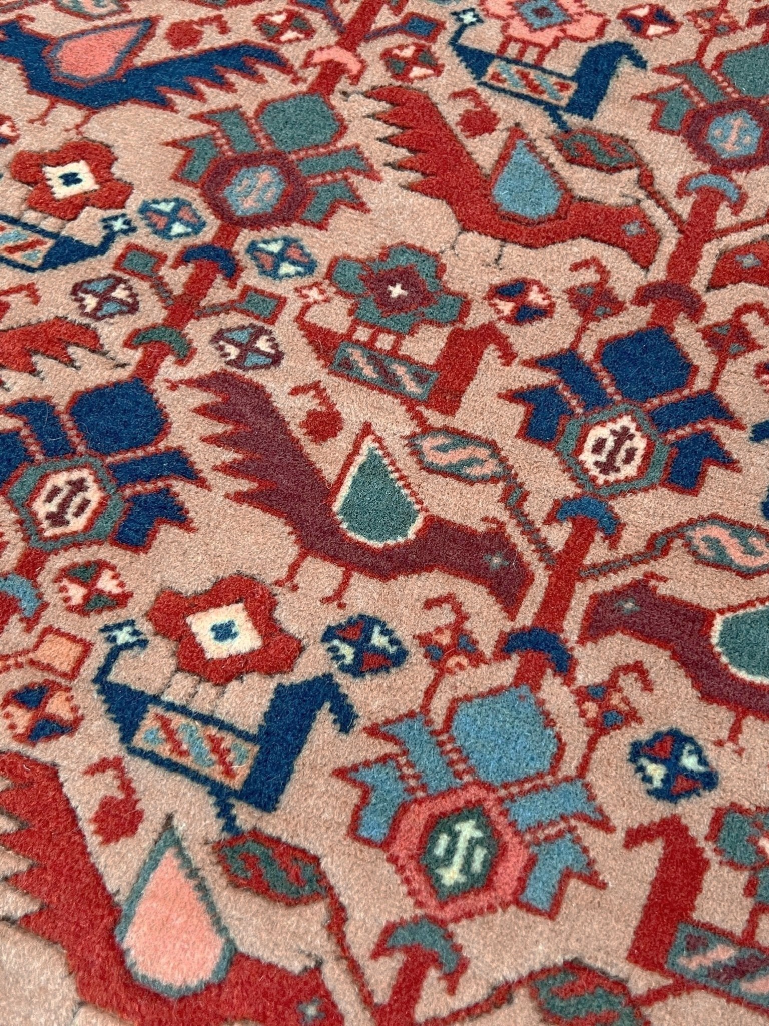 Brand new 6x9 handmade Turkish Tree of Life rug in pale salmon pink with birds, floral motifs, coral red and blue accents, traditional wool area rug from Indigo Rugs Burlingame Bay Area.