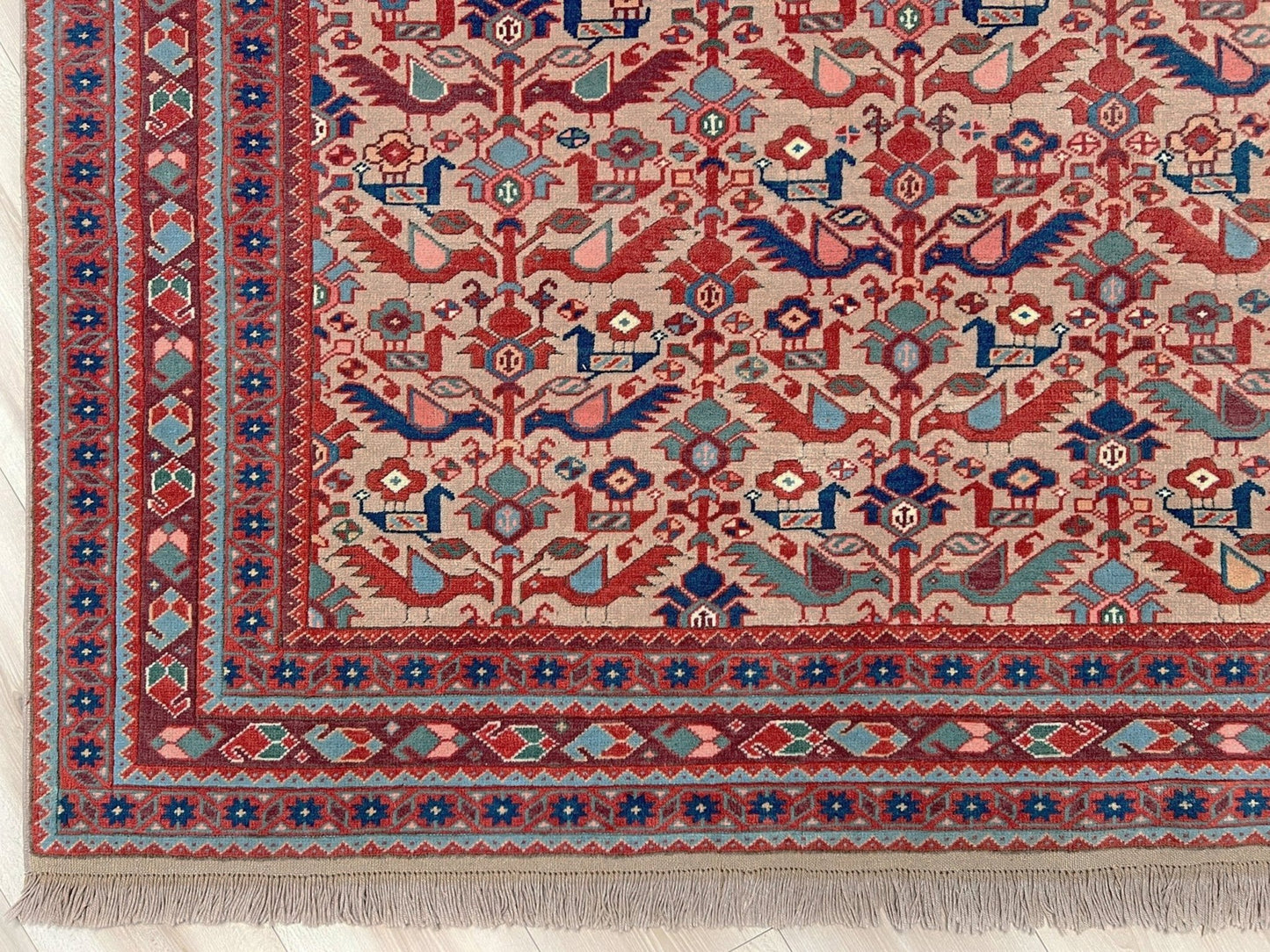 Brand new 6x9 handmade Turkish Tree of Life rug in muted peach with birds, floral motifs, coral red and blue accents, traditional wool area rug from Indigo Rugs Burlingame Bay Area.