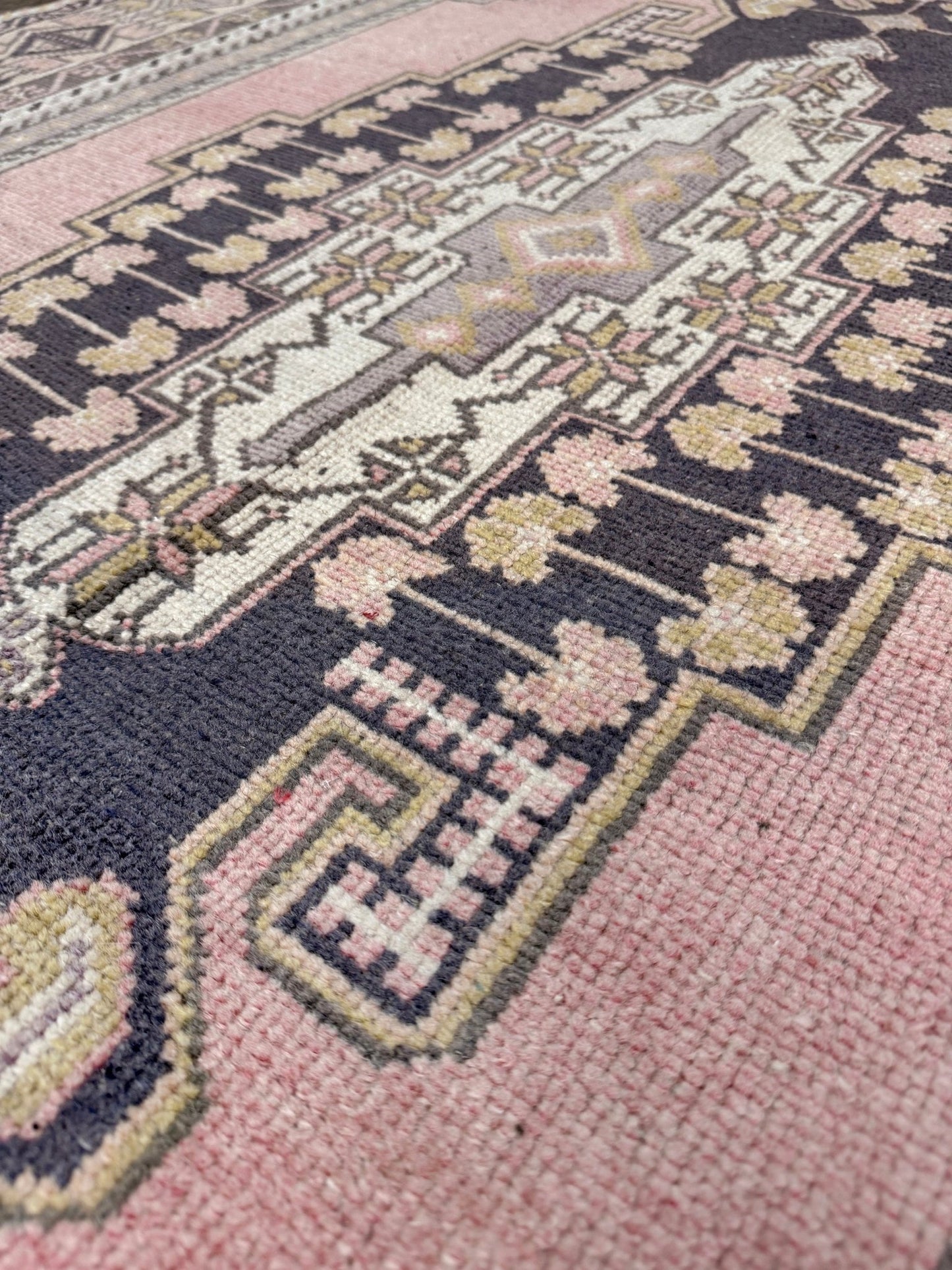 pastel vintage turkish obruk rug 4x7 handwoven anatolian wool rug dusty rose field charcoal navy medallion floral border low pile vintage rug indigo rugs san francisco bay area
