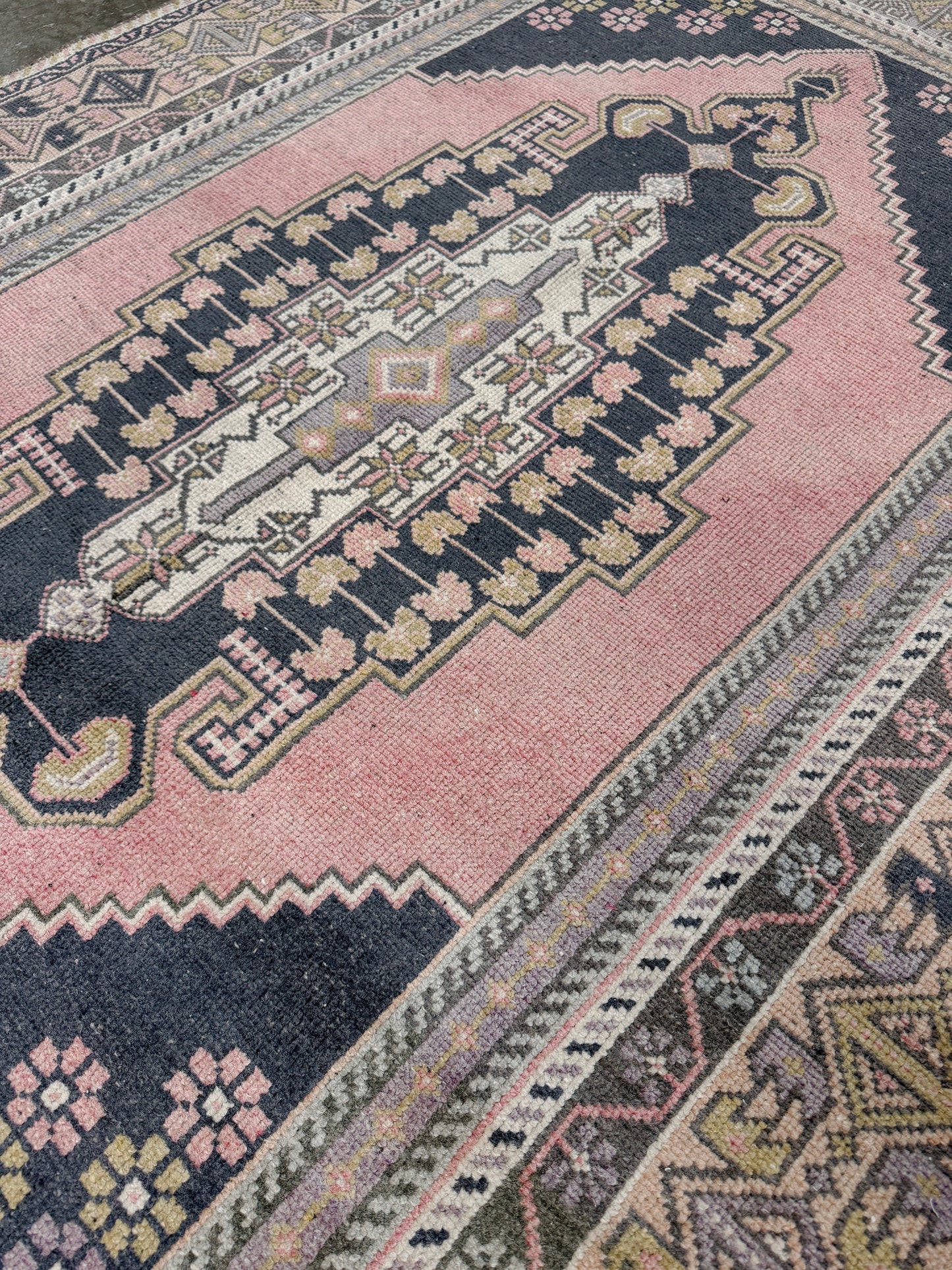 pastel vintage turkish obruk rug 4x7 handwoven anatolian wool rug dusty rose field charcoal navy medallion floral border low pile vintage rug indigo rugs san francisco bay area
