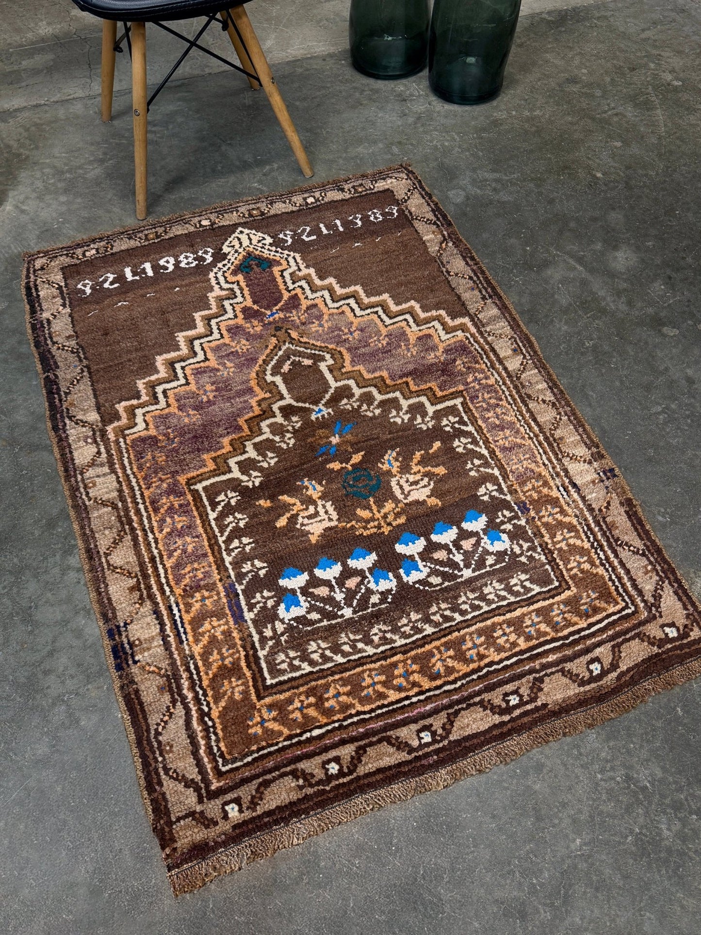 Decorative rug with intricate patterns on a gray floor. 3x4 Kars Wool vintage turkish mini rug. Handmade turkish rug shop san francisco bay area. Buy handmade wool rug online