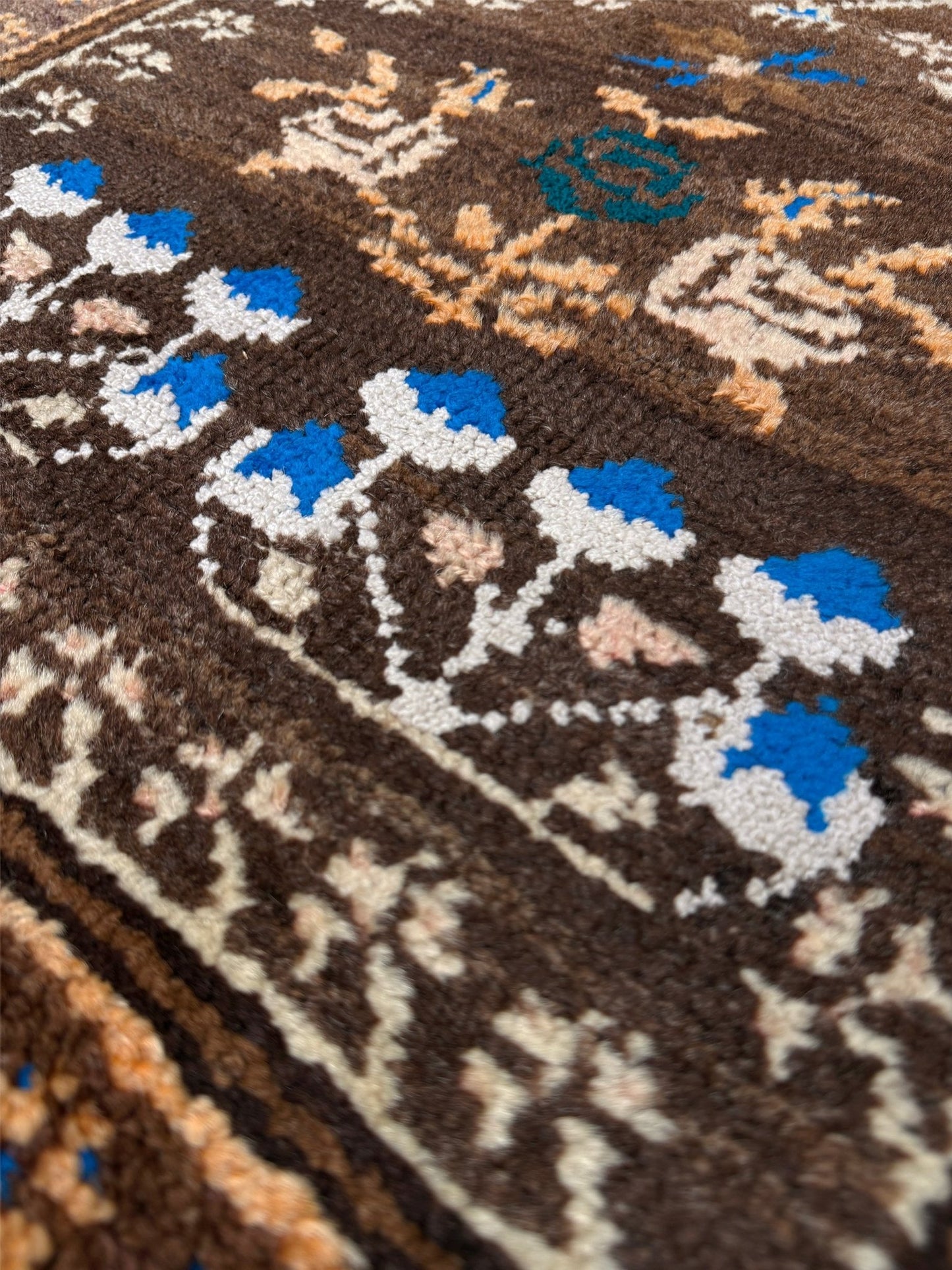 Close-up of a patterned rug with blue, white, and brown colors. 3x4 Kars Wool vintage turkish mini rug. Handmade turkish rug shop san francisco bay area. Buy handmade wool rug online