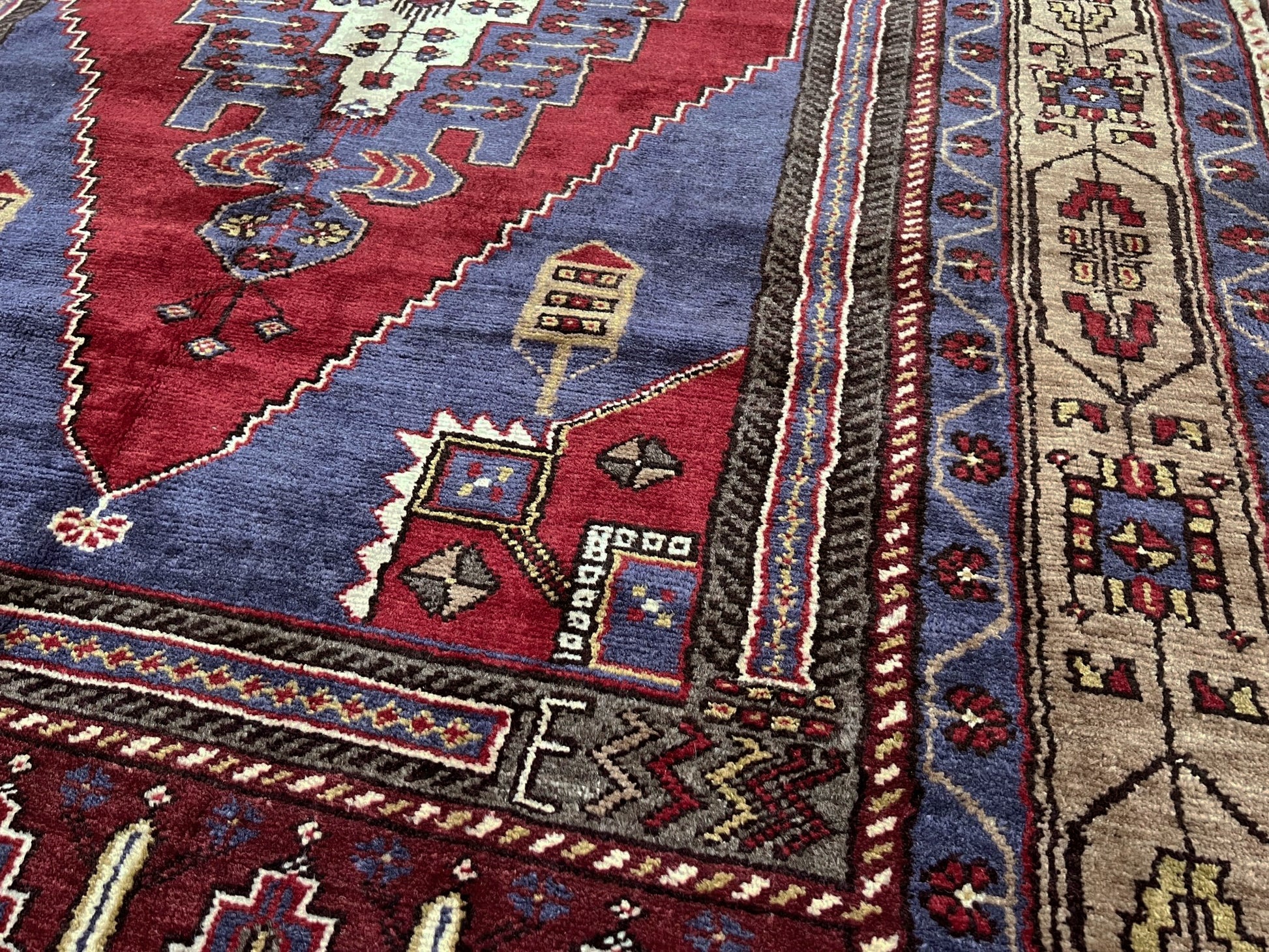 Vintage Taspinar Turkish rug (6x9) with ivory, brick red, and indigo medallion design—handmade wool, strong pile, excellent condition. Perfect for living rooms, bedrooms, or kitchens. Durable, tribal geometric style. Free shipping from Indigo Rugs, the best rug shop in Burlingame, Bay Area.
