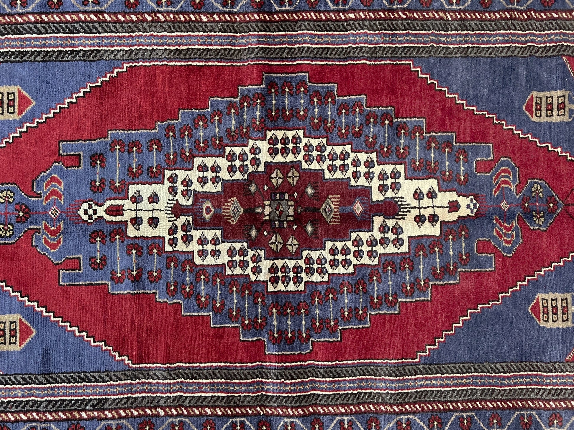 Vintage Taspinar Turkish rug (6x9) with ivory, brick red, and indigo medallion design—handmade wool, strong pile, excellent condition. Perfect for living rooms, bedrooms, or kitchens. Durable, tribal geometric style. Free shipping from Indigo Rugs, the best rug shop in Burlingame, Bay Area.