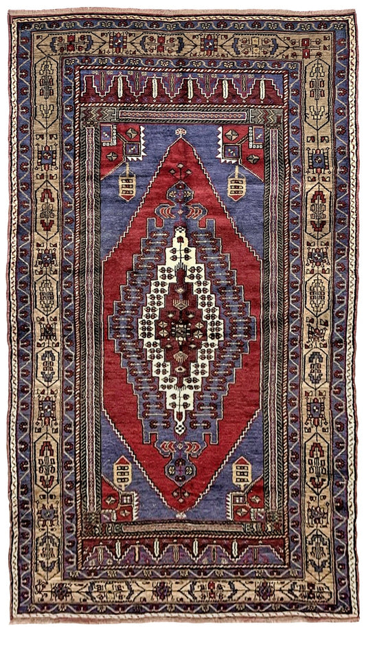 Vintage Taspinar Turkish rug (6x9) with ivory, brick red, and indigo medallion design—handmade wool, tribal geometric style rug from Indigo Rugs, the best rug shop in Burlingame, Bay Area.