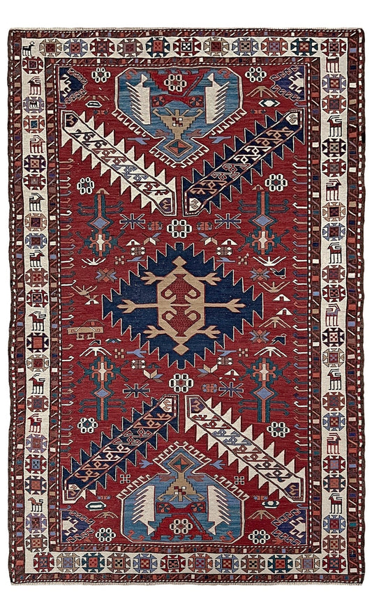 Vintage Shahsavan Persian Soumak flatweave rug featuring red, ivory, and blue tribal medallions — handmade Persian wool 3x5 wall hanging, available at Indigo Rugs, the best rug shop in San Francisco Bay Area, Burlingame CA.