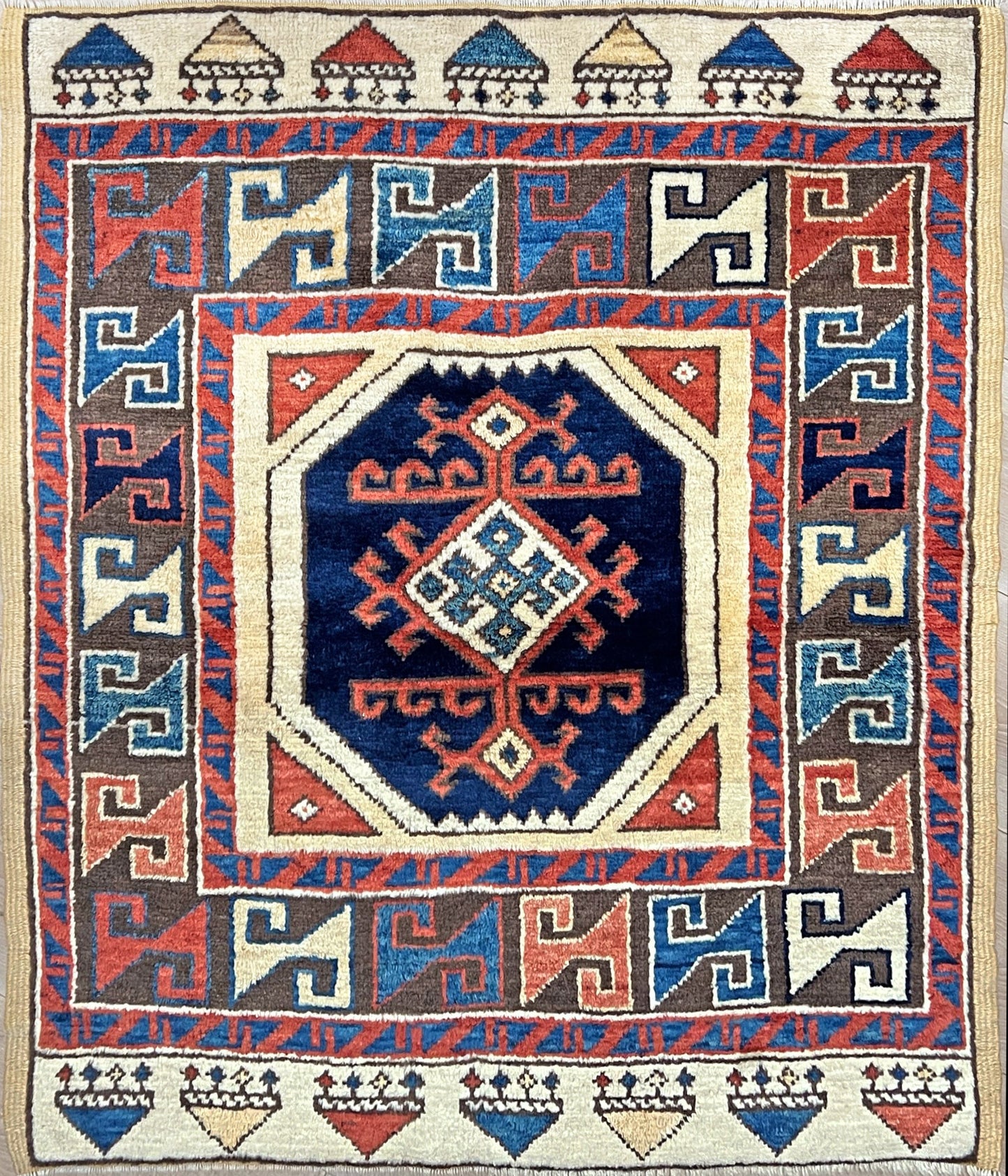 Turkish Konya handmade wool mini rug with geometric tribal medallion, navy field, and rust and ivory accents — 3×3.5 hand-knotted small carpet. square wool handmade Mini Rug rug shop san francisco bay area. Buy rug online free shipping USA Canada.