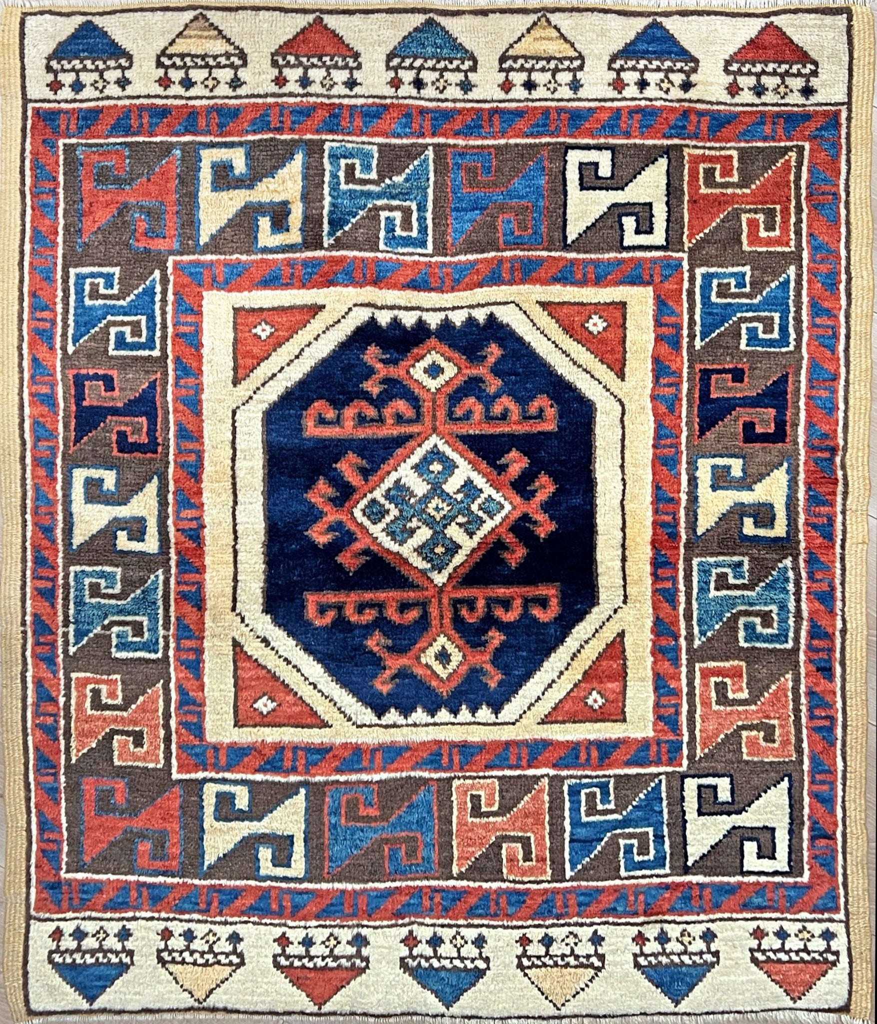 Turkish Konya handmade wool mini rug with geometric tribal medallion, navy field, and rust and ivory accents — 3×3.5 hand-knotted small carpet. square wool handmade Mini Rug rug shop san francisco bay area. Buy rug online free shipping USA Canada.