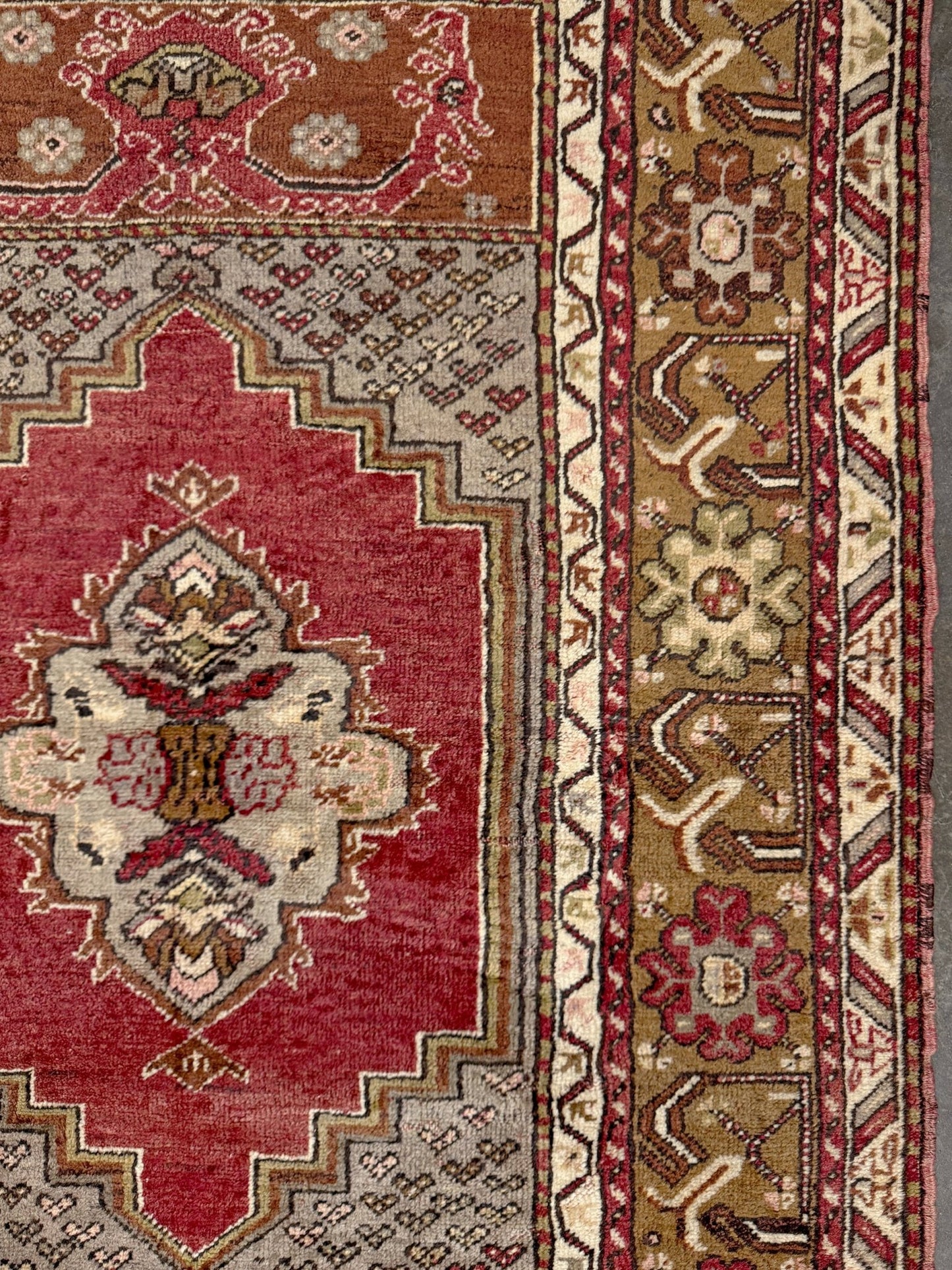 Vintage Turkish Kirsehir rug with russet red field and geometric medallion, hand-knotted wool pile on wool foundation, featuring camel, taupe, and faded gold floral borders — 1950s Anatolian small accent rug 3x5.