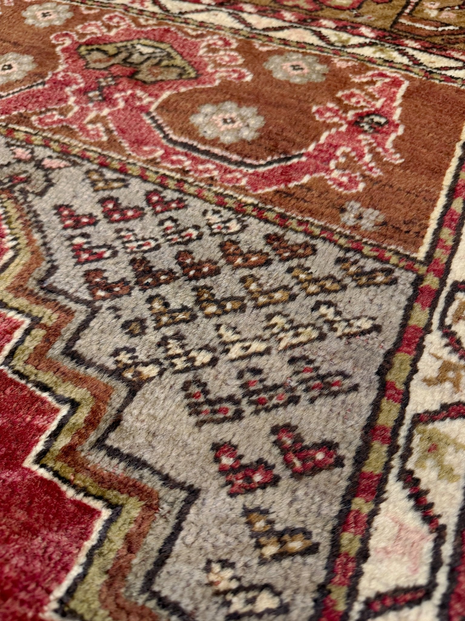 Vintage Turkish Kirsehir rug with russet red field and geometric medallion, hand-knotted wool pile on wool foundation, featuring camel, taupe, and faded gold floral borders — 1950s Anatolian small accent rug 3x5.