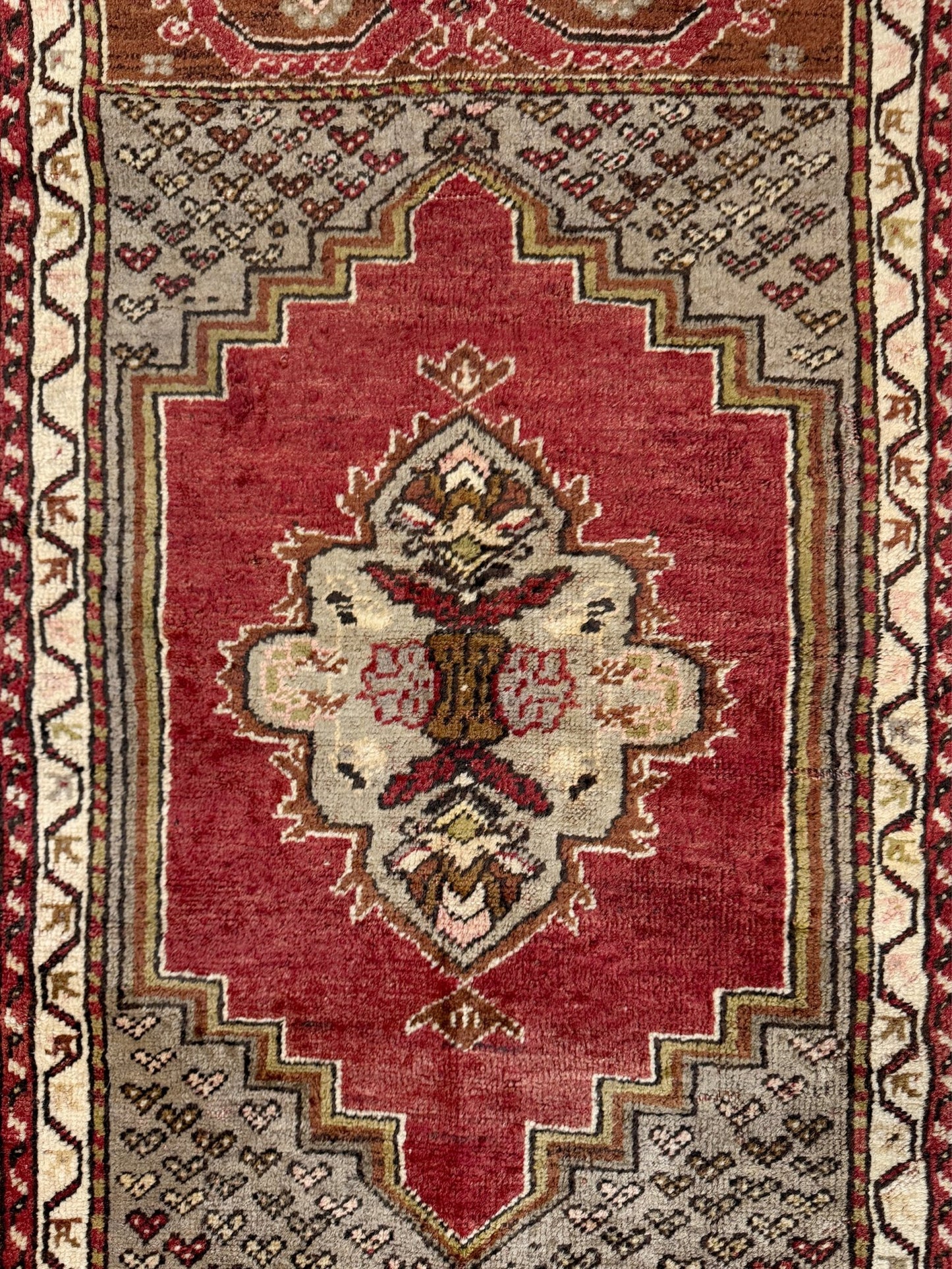 Vintage Turkish Kirsehir rug with russet red field and geometric medallion, hand-knotted wool pile on wool foundation, featuring camel, taupe, and faded gold floral borders — 1950s Anatolian small accent rug 3x5.