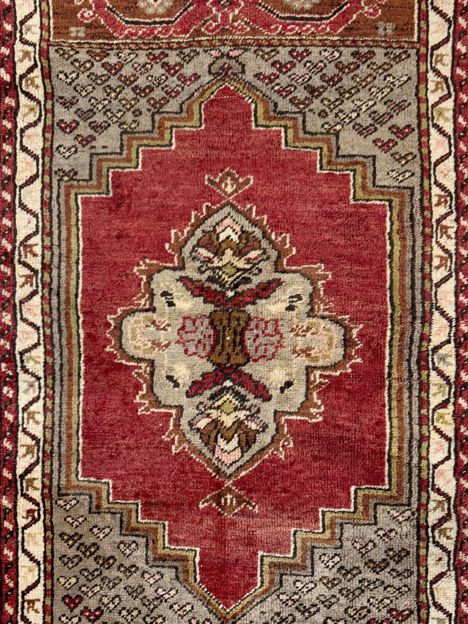 Vintage Turkish Kirsehir rug with russet red field and geometric medallion, hand-knotted wool pile on wool foundation, featuring camel, taupe, and faded gold floral borders — 1950s Anatolian small accent rug 3x5.