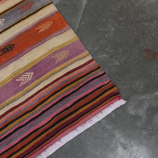 Vintage Anatolian kilim rug, 6x8 with horizontal arrow motifs in sun-washed tones.